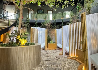 Serene garden area at Aurora Spa I أورورا سبا, Riyadh, Riyadh Province, SA with elegant decor and seating.