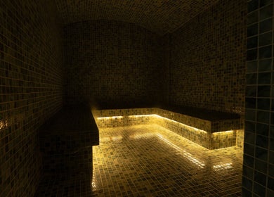 Luxurious steam room at Aurora Spa I أورورا سبا in Riyadh, Riyadh Province, SA with warm ambient lighting.