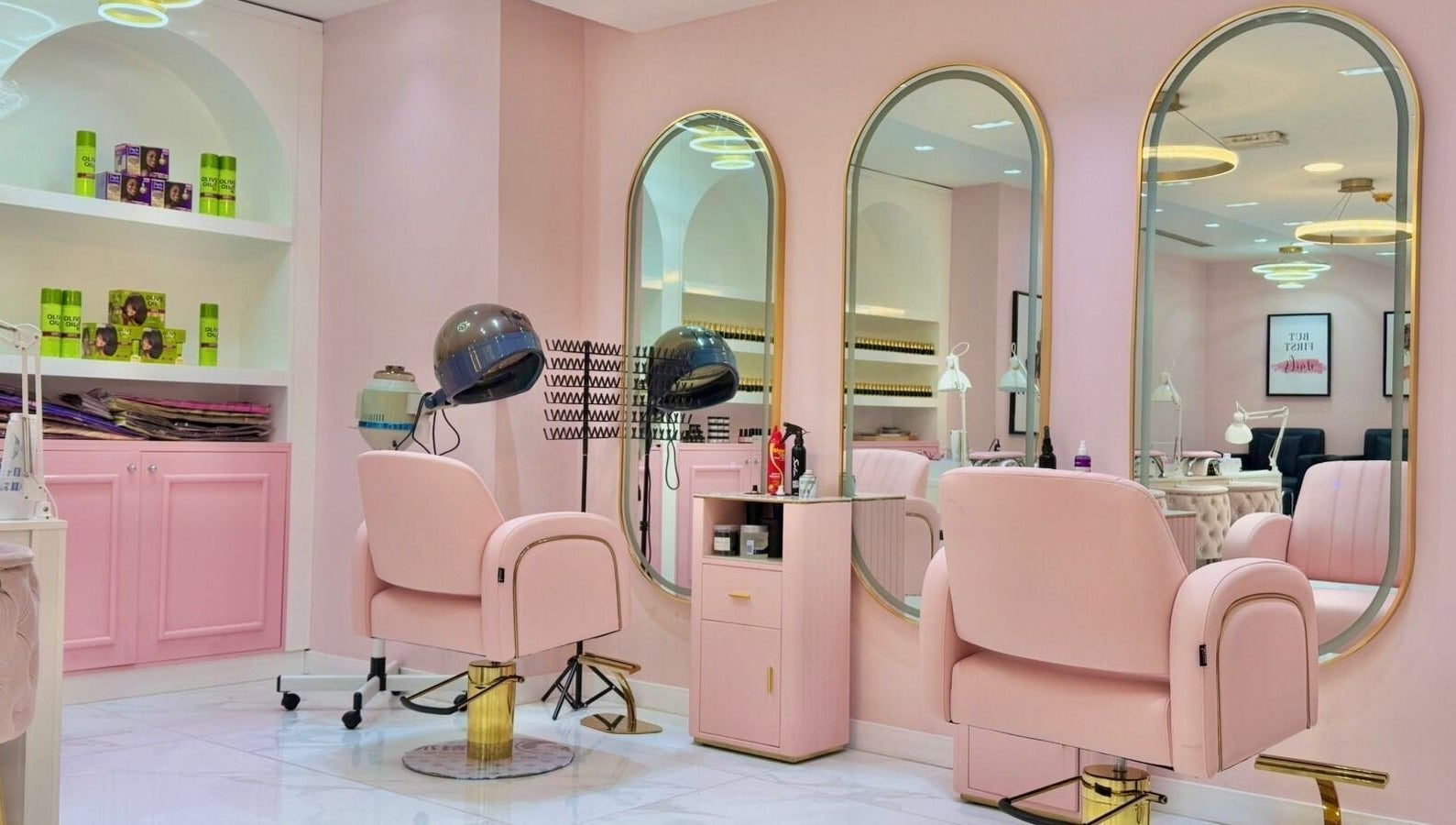 Beauty By Bella Salon in Dubai, Dubai, AE with elegant pink and gold furnishings and styling stations.