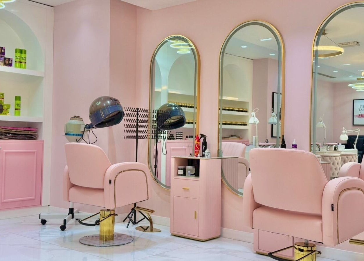 Beauty By Bella Salon in Dubai, Dubai, AE with elegant pink and gold furnishings and styling stations.