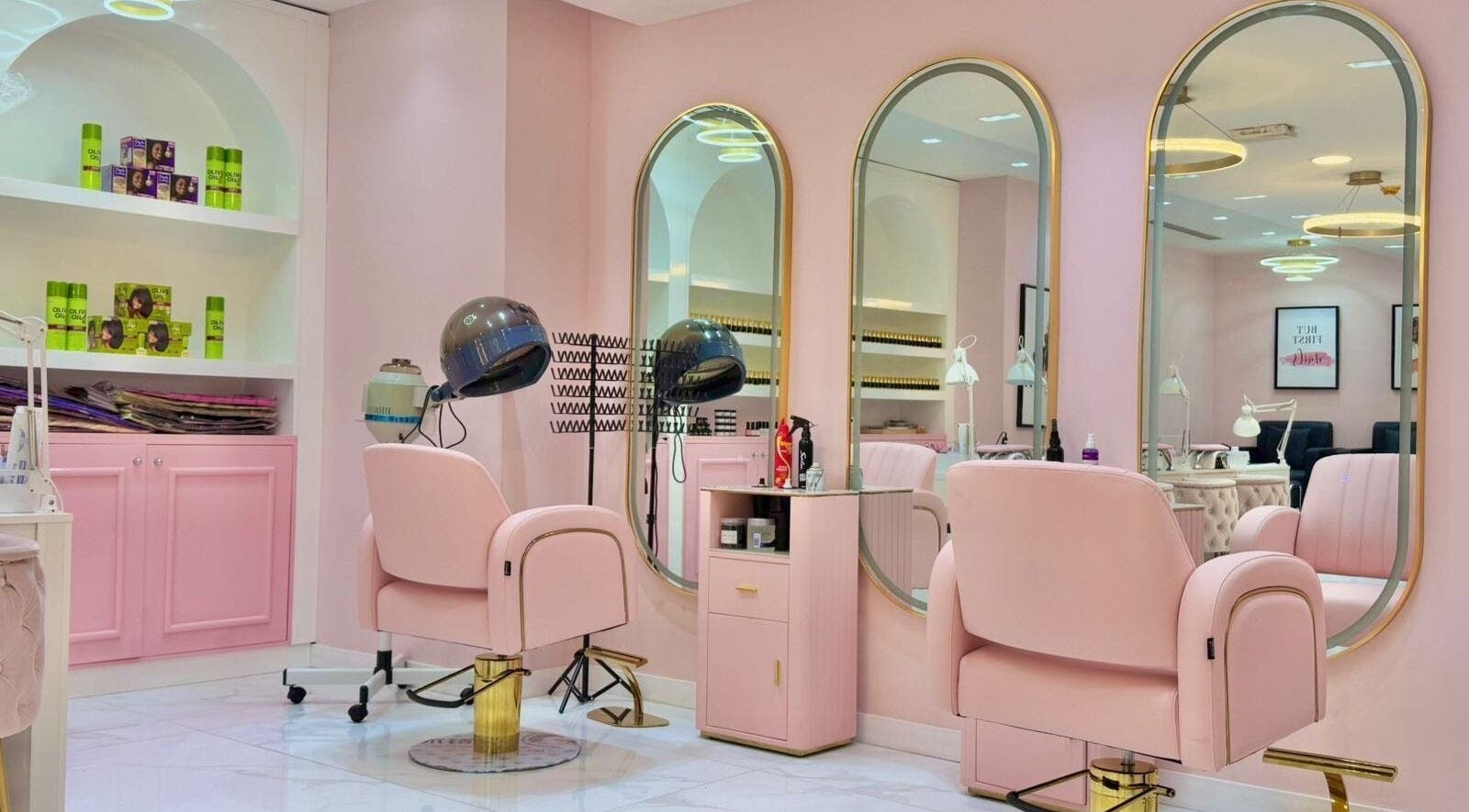 Beauty By Bella Salon in Dubai, Dubai, AE with elegant pink and gold furnishings and styling stations.