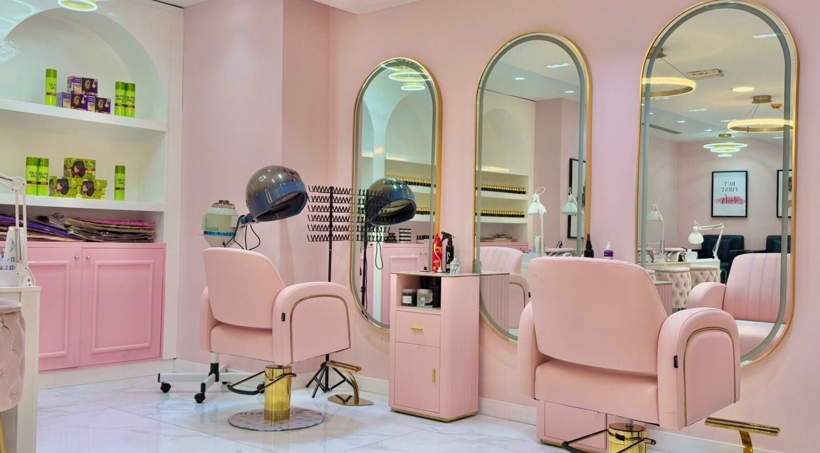 Beauty By Bella Salon in Dubai, Dubai, AE with elegant pink and gold furnishings and styling stations.