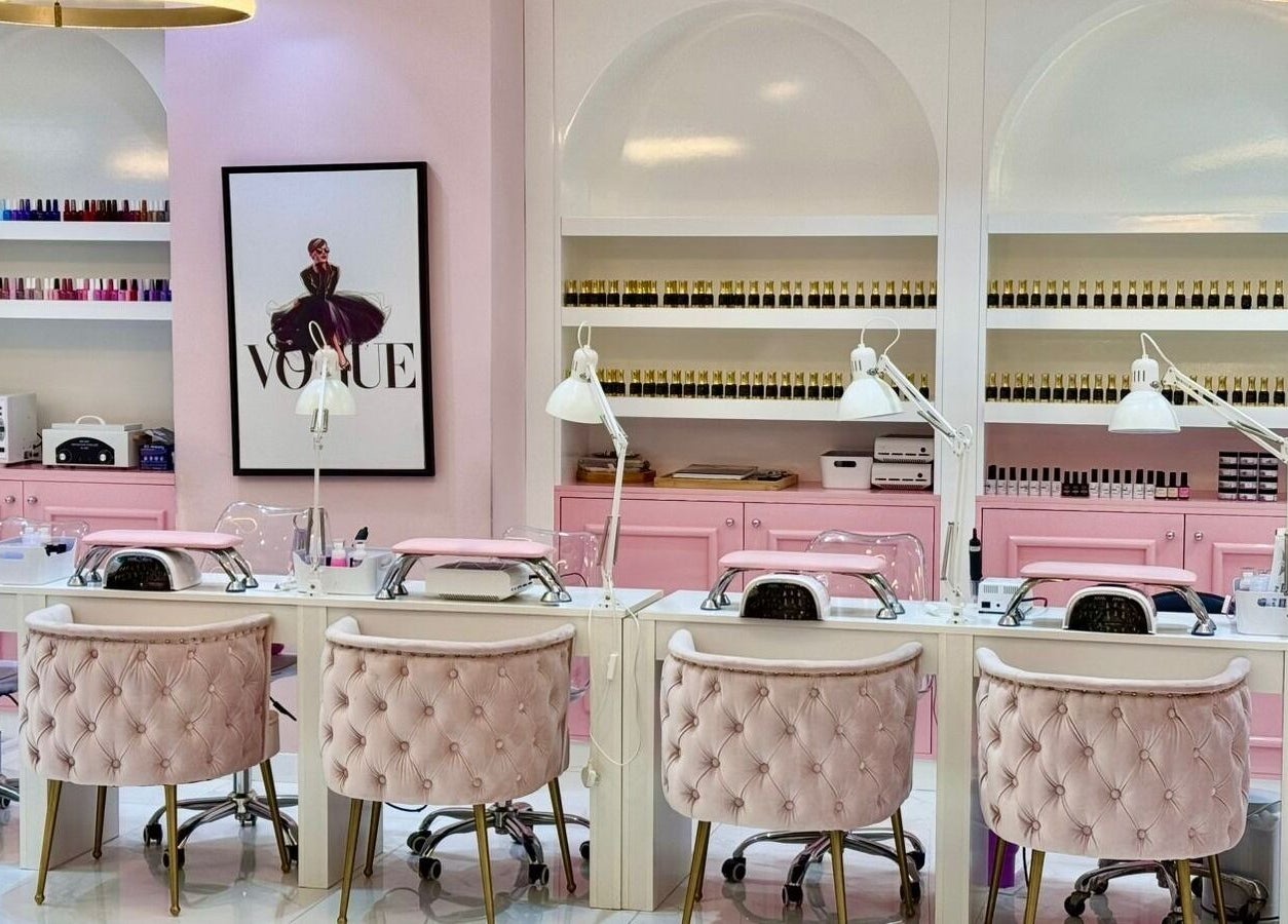 Luxury nail stations at Beauty By Bella Salon in Dubai, Dubai, AE, with pink decor and elegant seating.