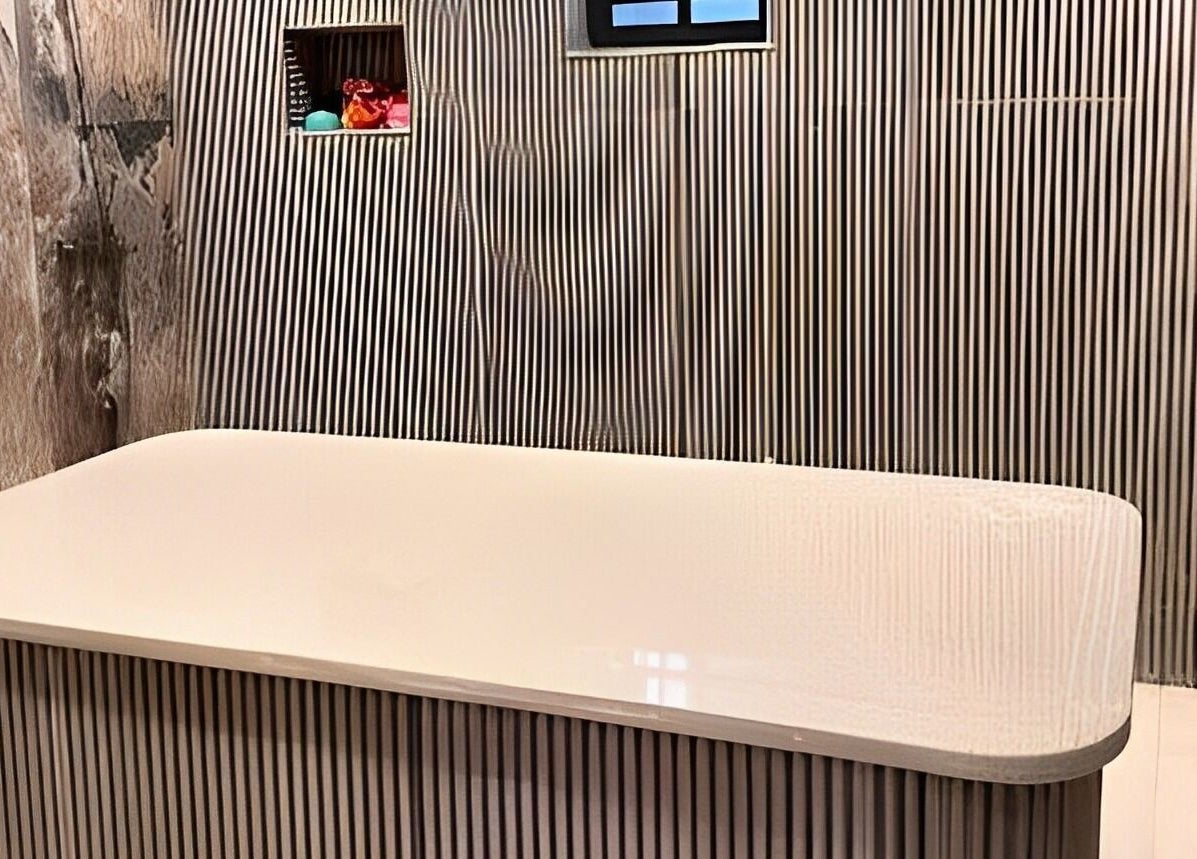 Relaxing treatment room at Indigoluxe spa, Lagos, Lagos, NG, featuring a sleek modern design.