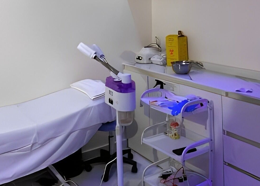 Tranquil treatment room at Indigoluxe Spa, Lagos, NG with modern equipment and a white massage bed.