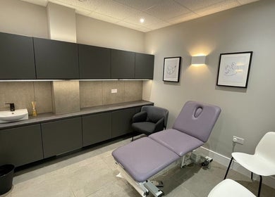 Elegant wellness room at By Serwah Wellness Wimbledon in London, England, GB featuring a plush treatment bed.