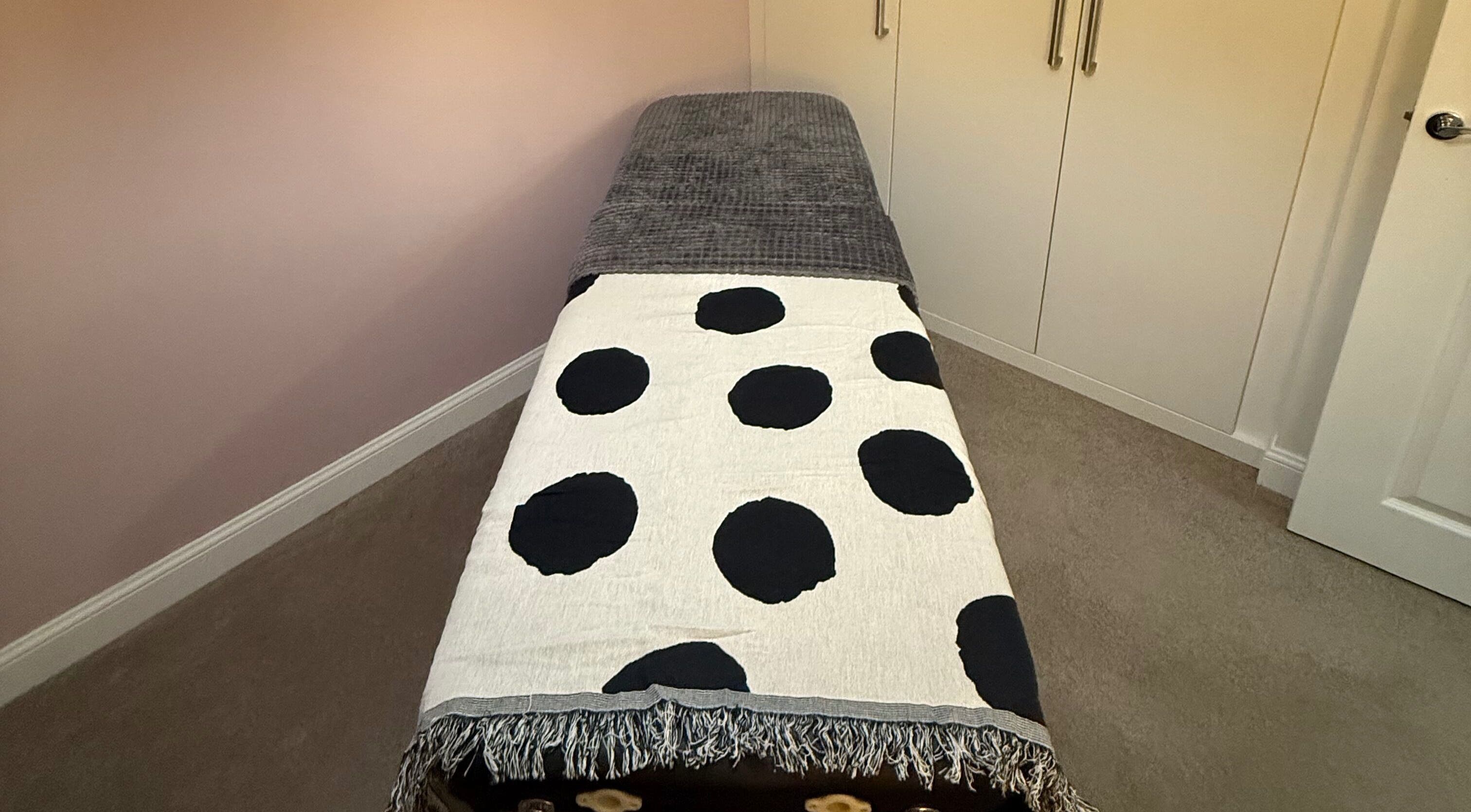 Cozy massage bed with polka dot throw at Essence Beauty in Barnsley, England, GB.