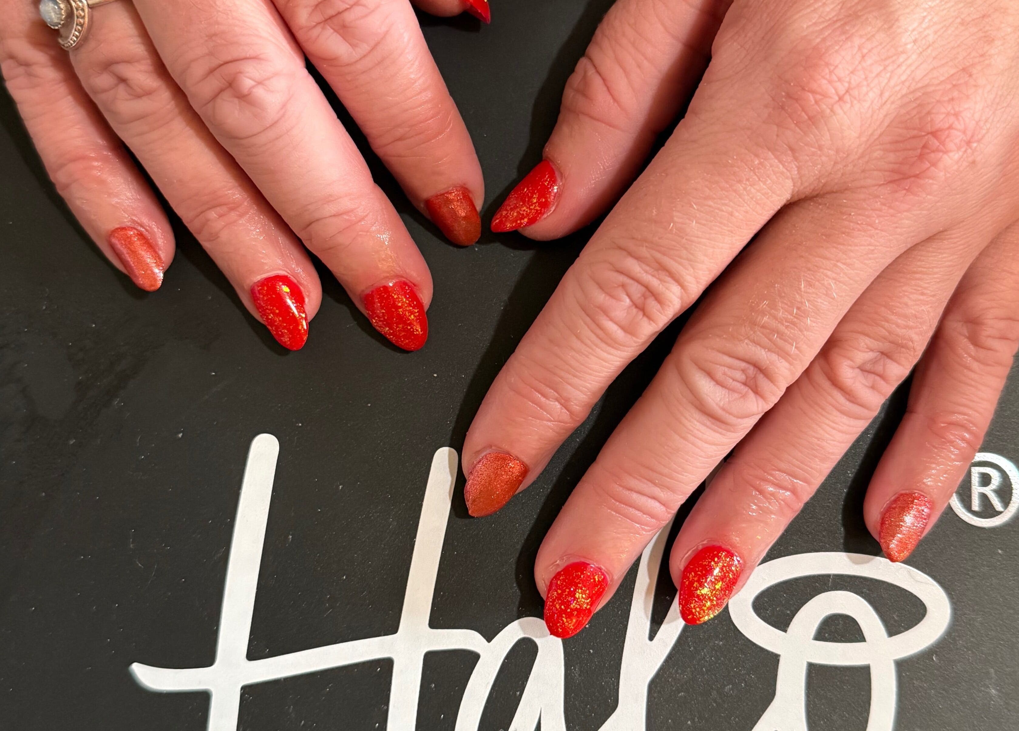 Vibrant red and orange nails at Essence Beauty, Barnsley, England, GB.