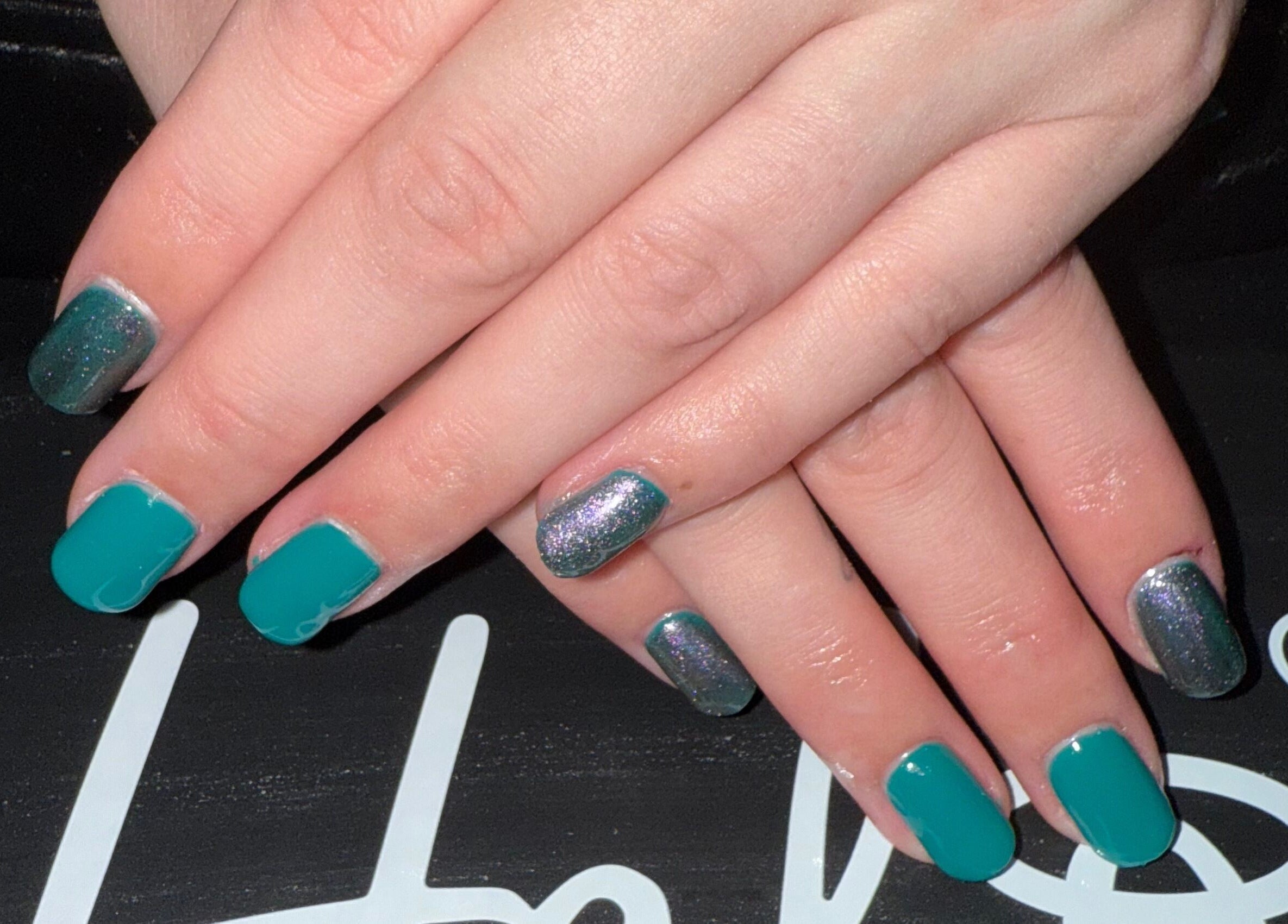 Stylish teal and glitter nail art at Essence Beauty, Barnsley, England, GB.