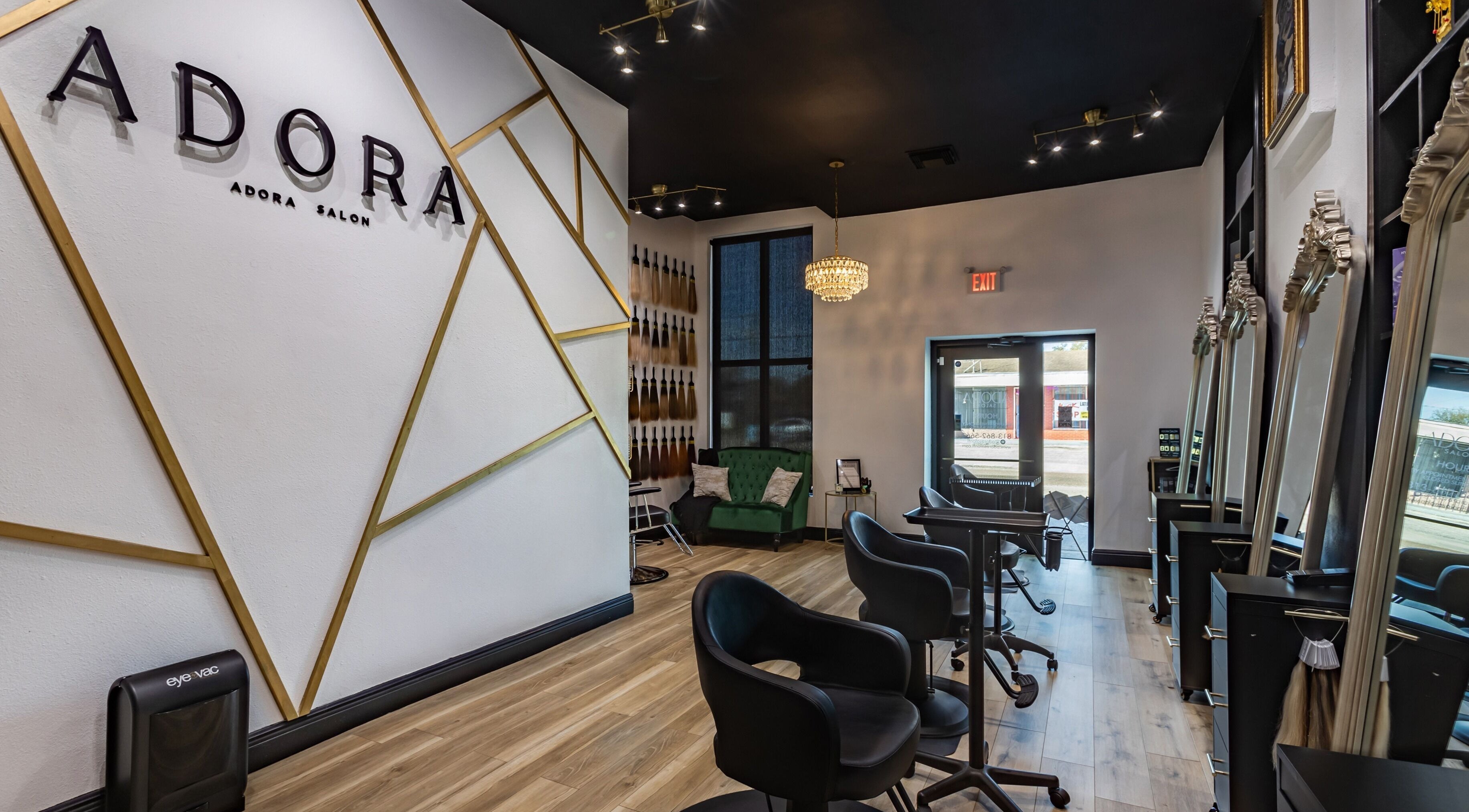 Interior of Adora Salon, Tampa, Florida, US, featuring stylish chairs and modern decor under soft lighting.