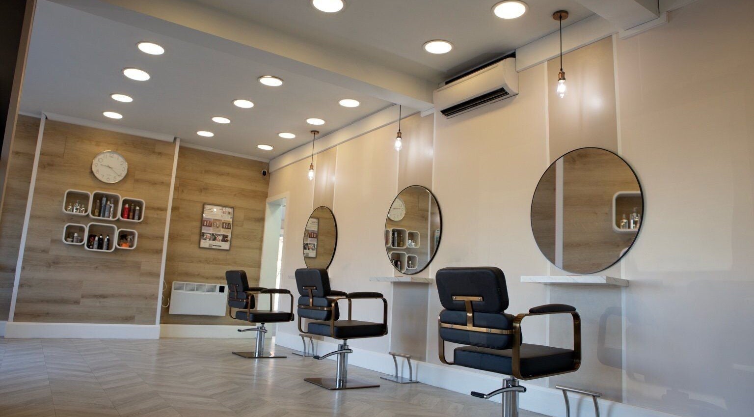 Modern salon interior at Hair Addiction Kirsty Nicole in Birstall, England, GB with sleek styling stations.
