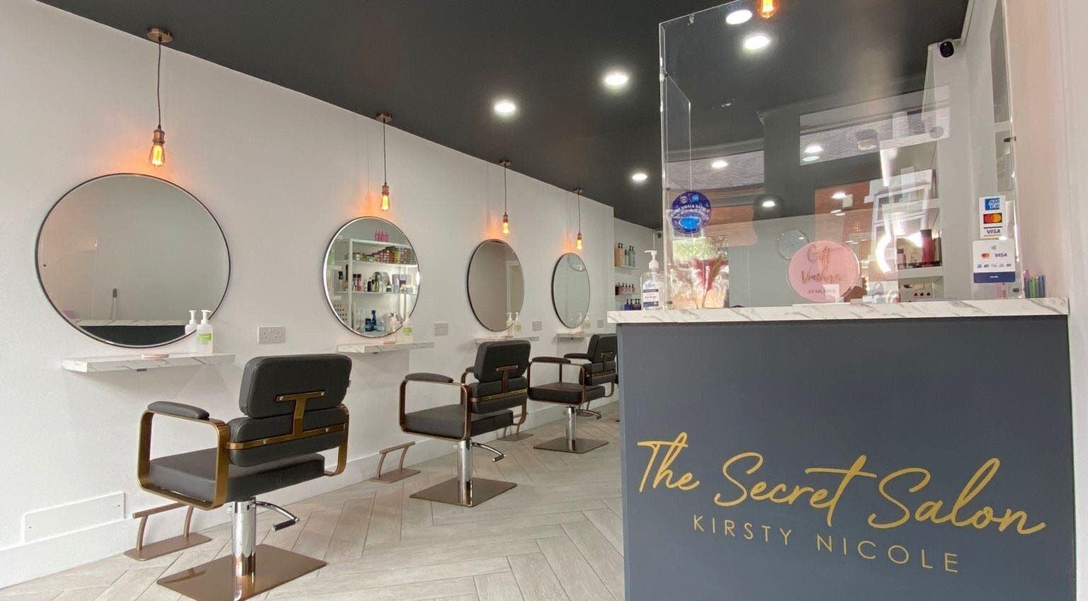 Interior of The Secret Salon Kirsty Nicole in Kirby Muxloe, England, GB with stylish salon chairs and mirrors.