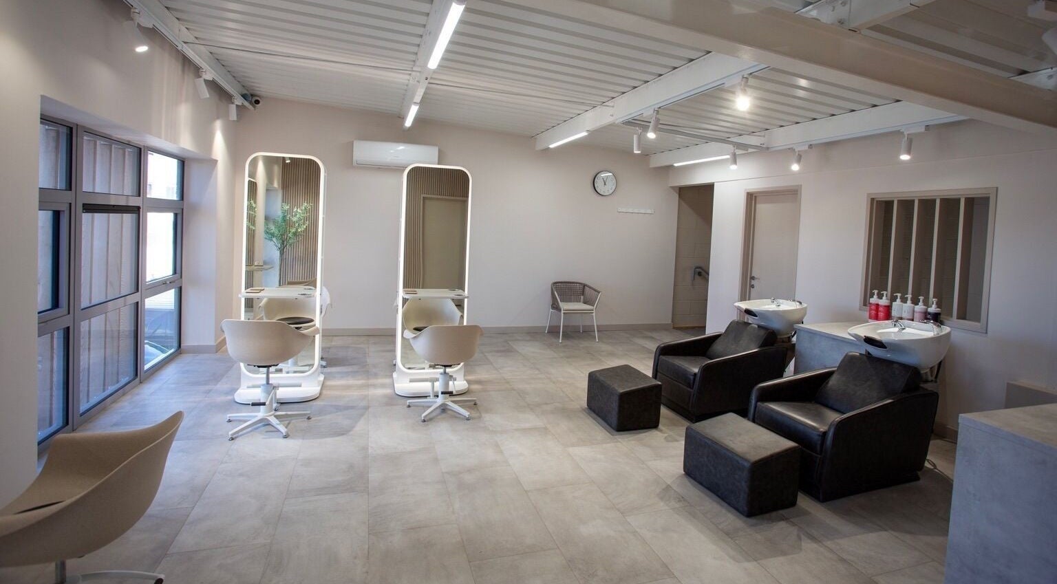 Modern salon interior at Kirsty Nicole in Glenfield, England, GB showcasing stylish chairs and mirrors.