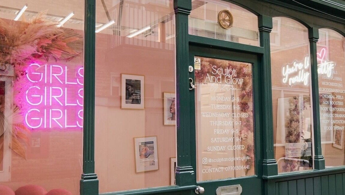 Front of Sculpt and Glow by Katrina in Brentwood with pink neon sign and service hours.