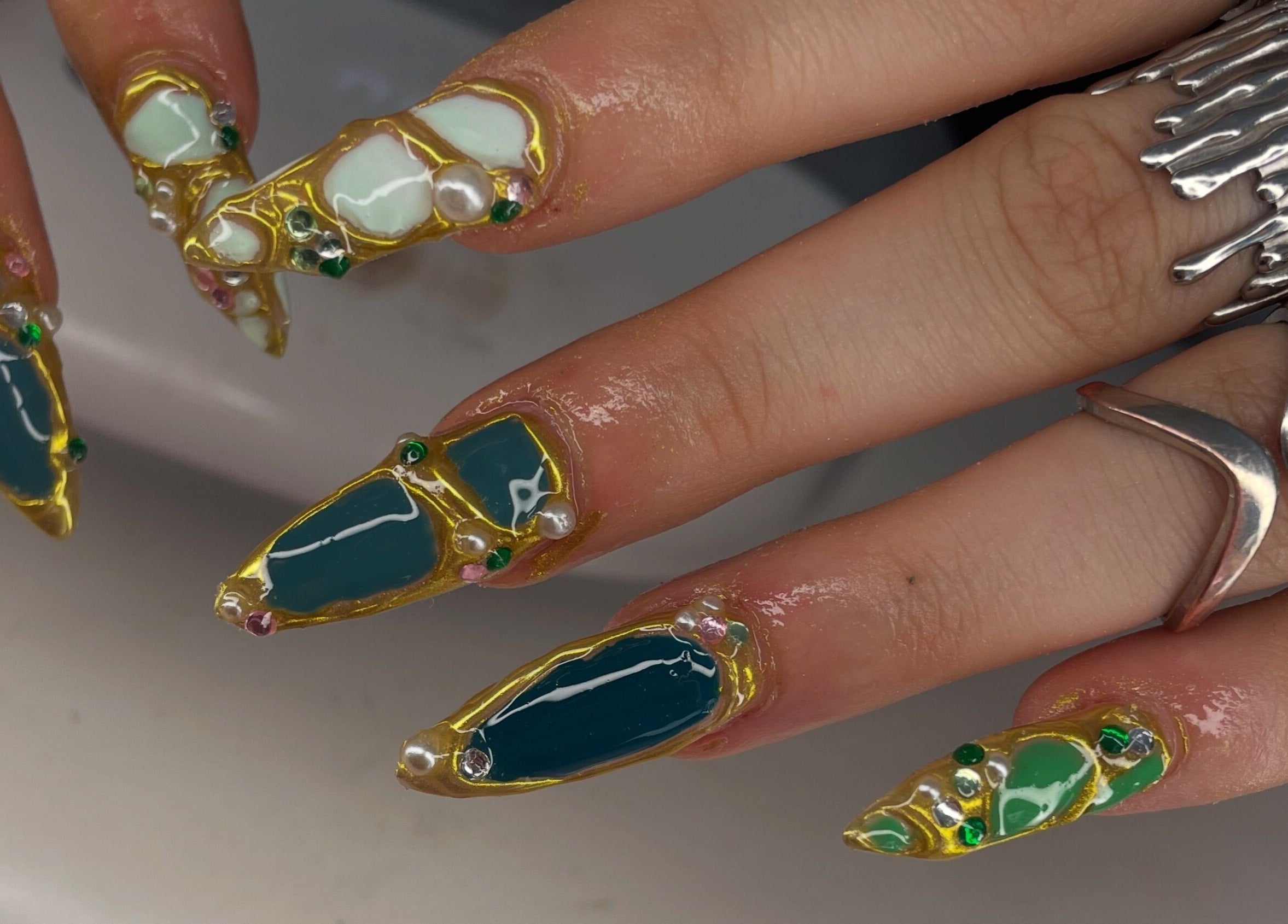 Intricate gemstone nail art by Nails.byavagray, Dunfermline, Scotland, GB showcasing unique vibrant designs.