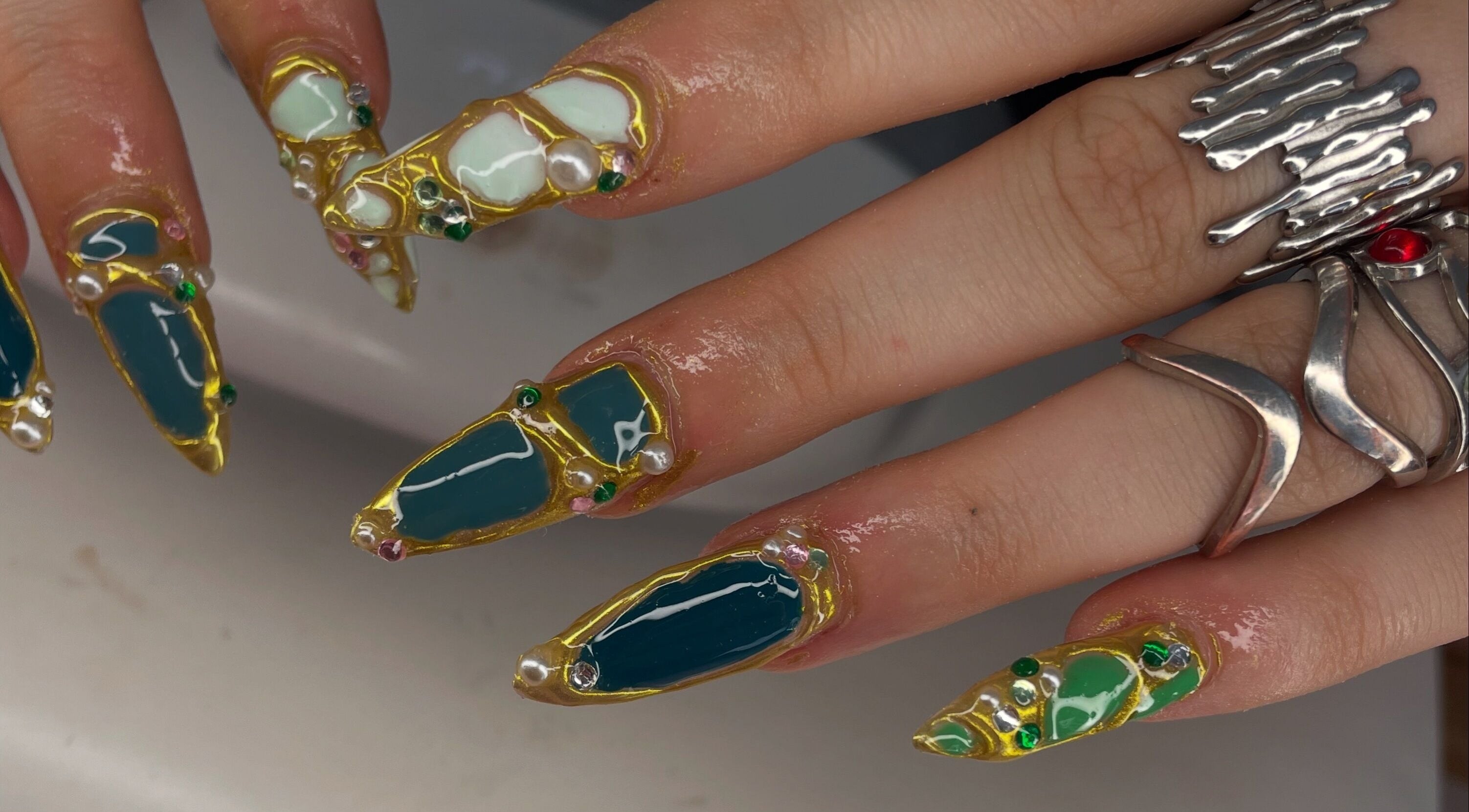 Intricate gemstone nail art by Nails.byavagray, Dunfermline, Scotland, GB showcasing unique vibrant designs.
