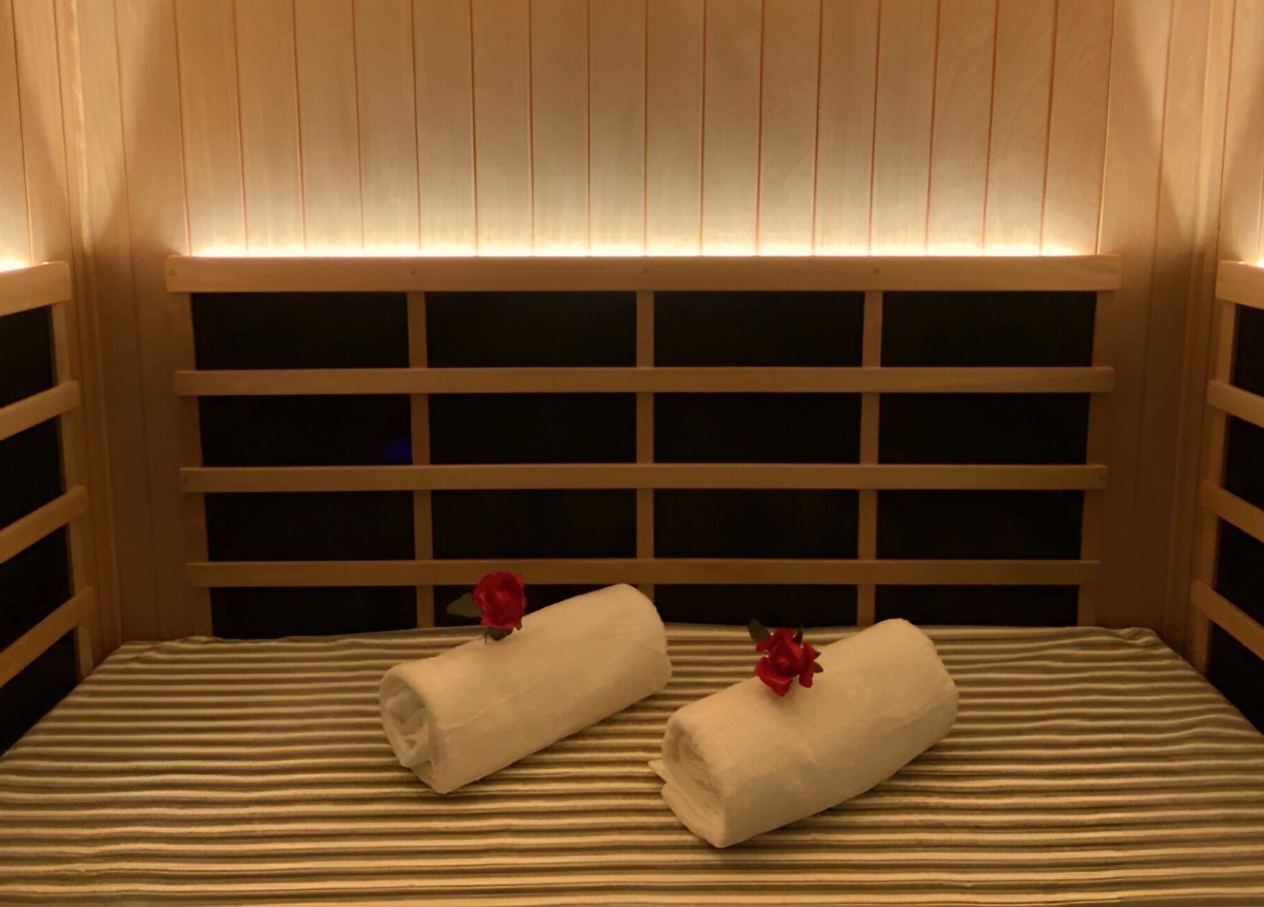 Relaxing sauna at Chi Foot Spa, Williamsburg, Virginia, US, with rolled towels and cozy ambiance.