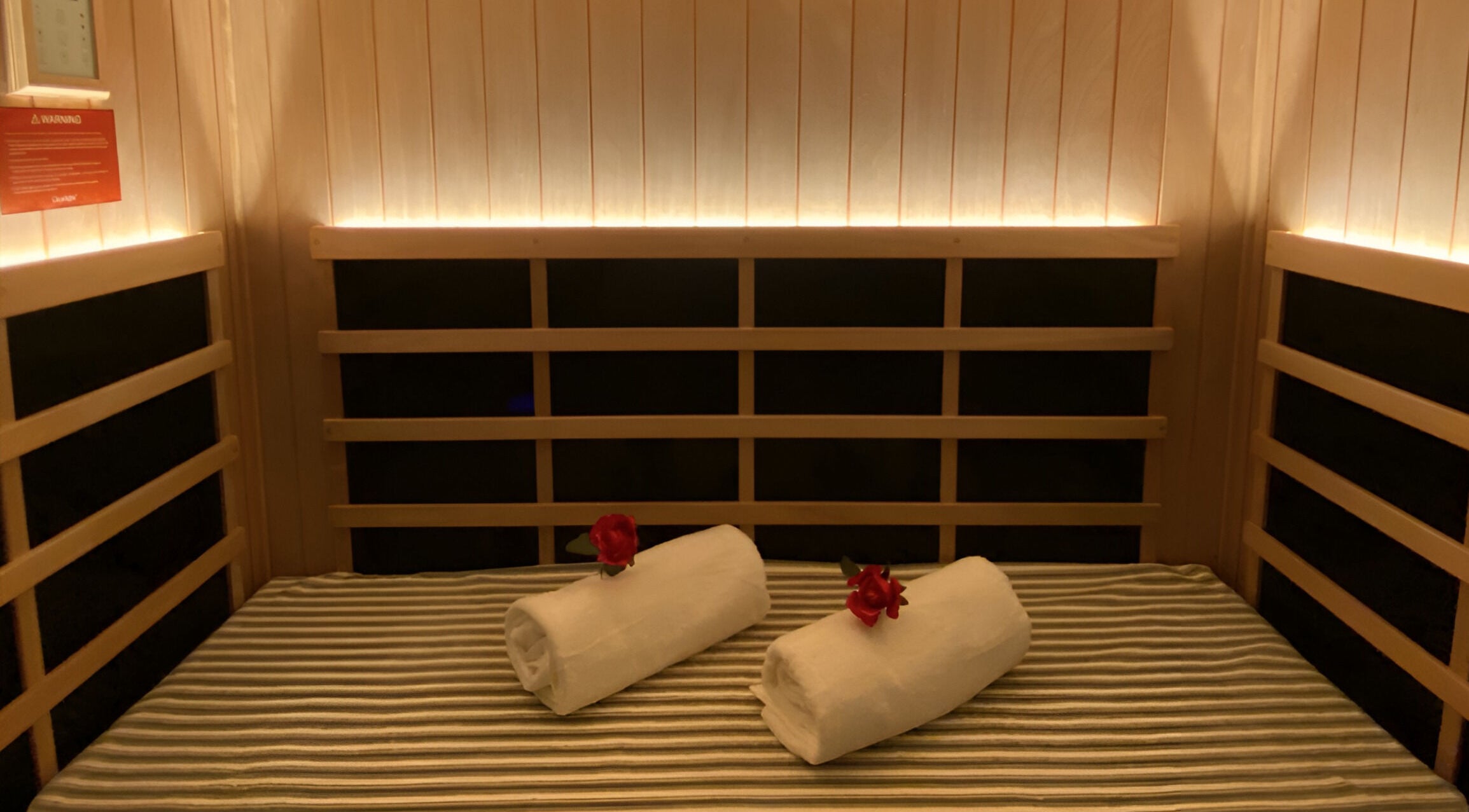 Relaxing sauna at Chi Foot Spa, Williamsburg, Virginia, US, with rolled towels and cozy ambiance.
