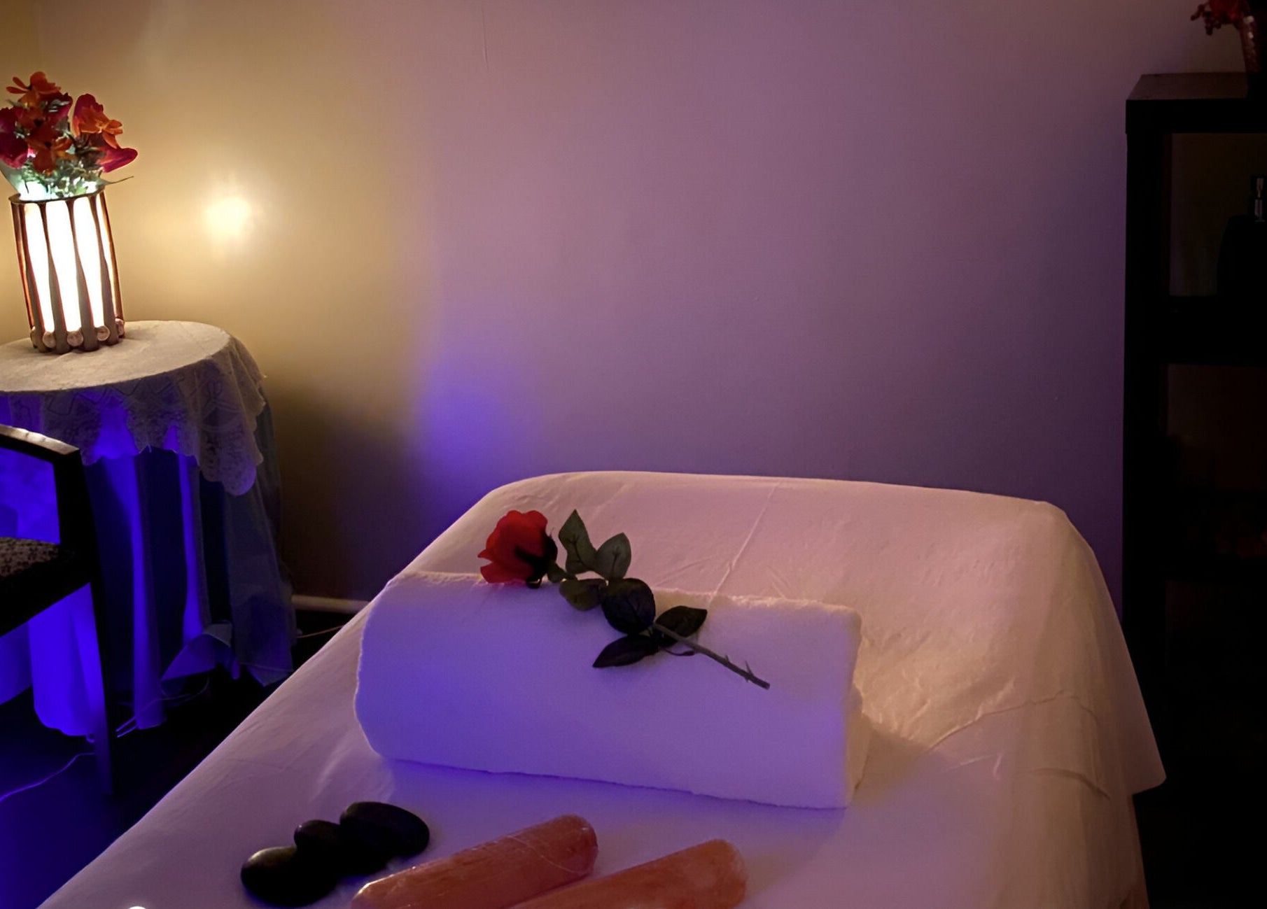 Serene massage room at Chi Foot Spa in Williamsburg, Virginia, US, with a softly lit table and peaceful ambiance.