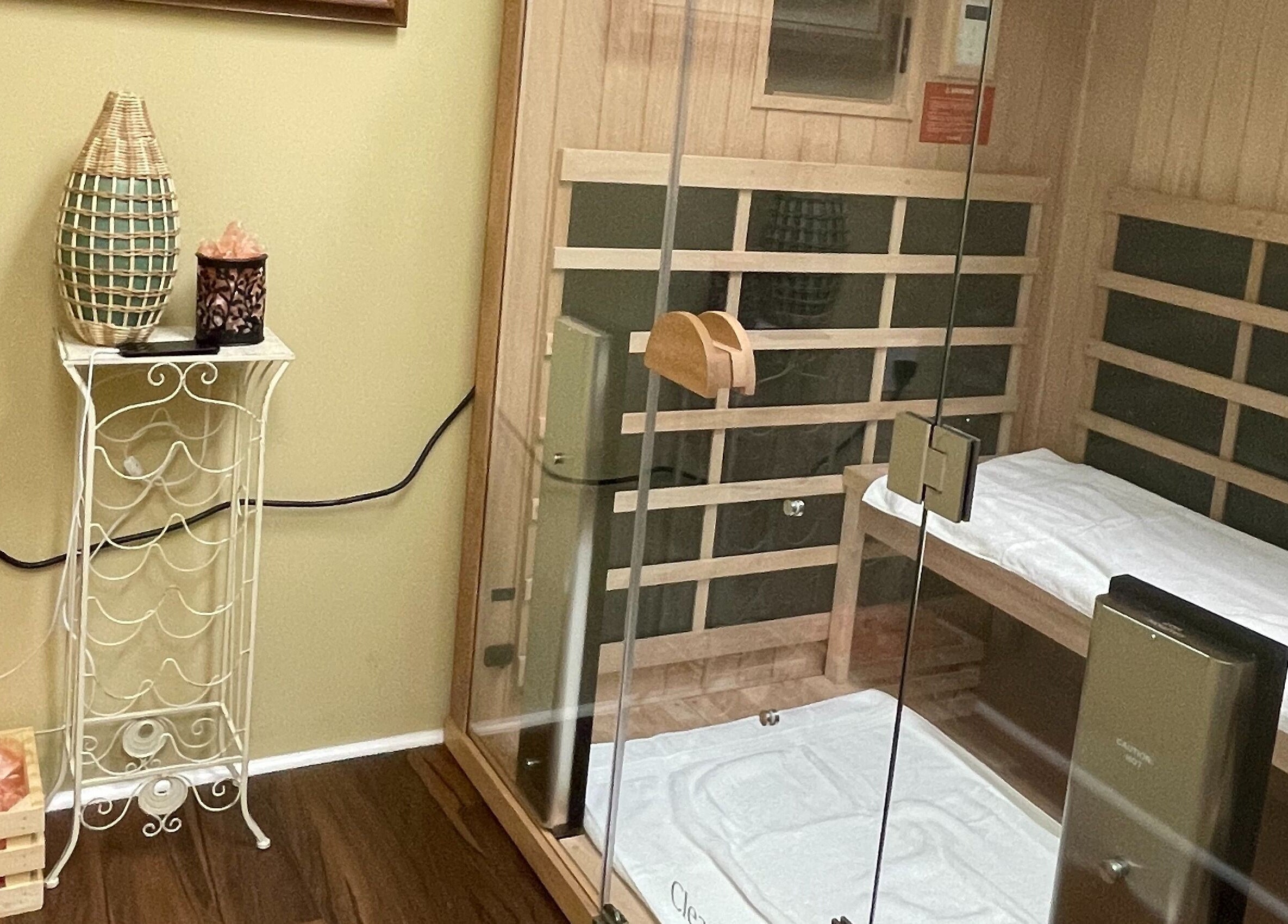 Relaxing sauna room at Chi Foot Spa, Williamsburg, Virginia, US with wooden benches and calming decor.