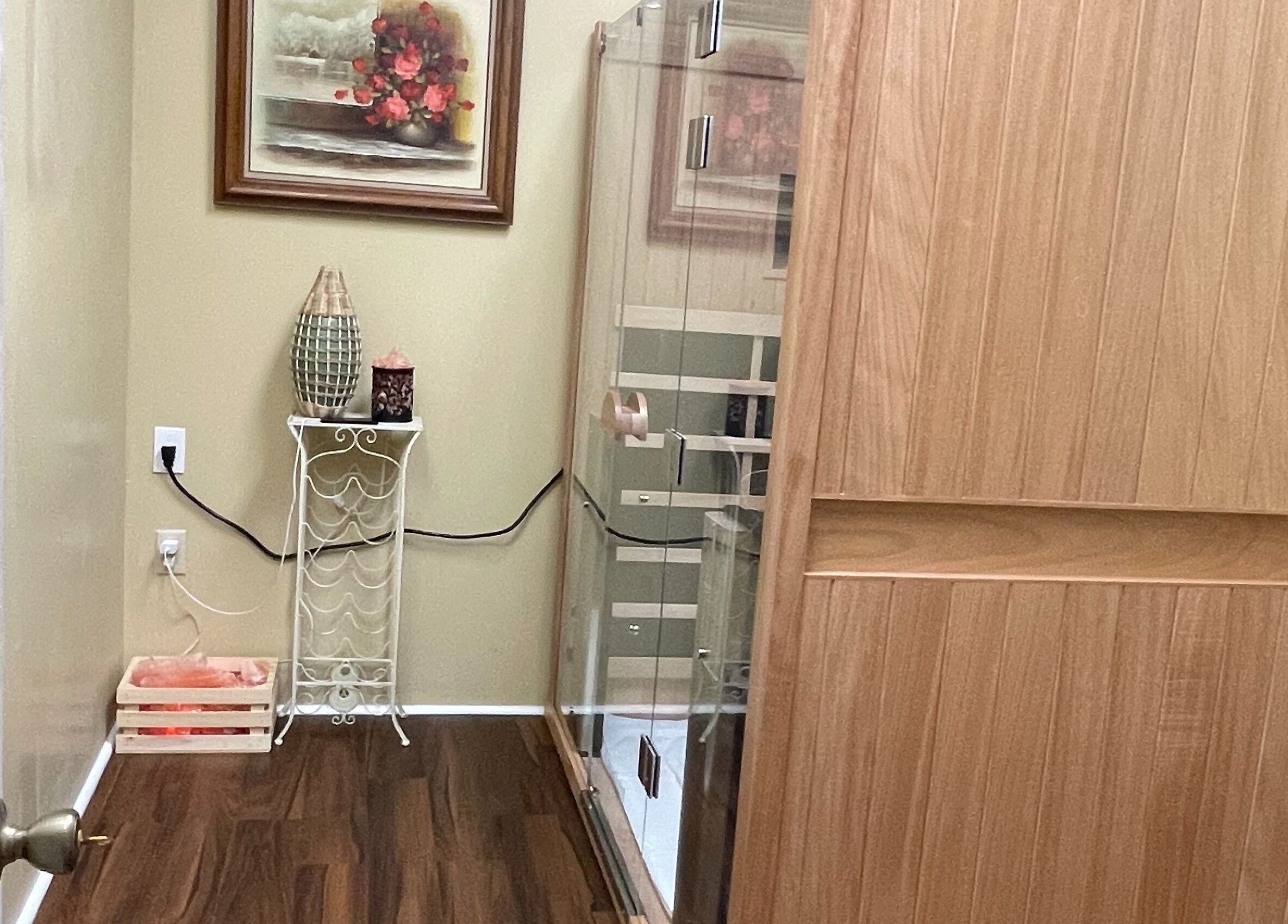 Calm corner at Chi Foot Spa, Williamsburg, Virginia, US with wooden decor and glass shower.