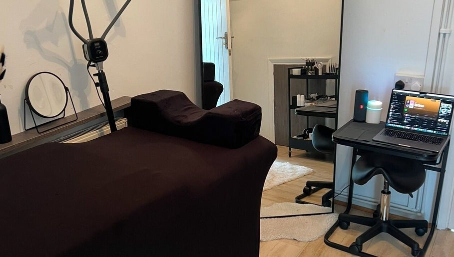 Tranquil treatment room at Signature Aesthetics, London, England, GB featuring a therapy bed and sleek décor.