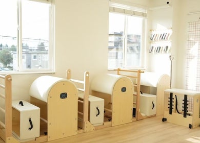 Bright Pilates equipment in Li Pilates studio, Burnaby, British Columbia, CA, with natural light streaming through windows.