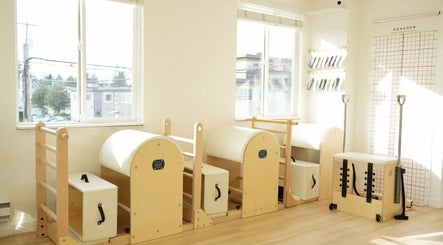 Bright Pilates equipment in Li Pilates studio, Burnaby, British Columbia, CA, with natural light streaming through windows.