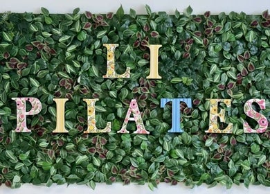 Li Pilates sign with leafy backdrop at Burnaby, British Columbia, CA inviting wellness seekers.