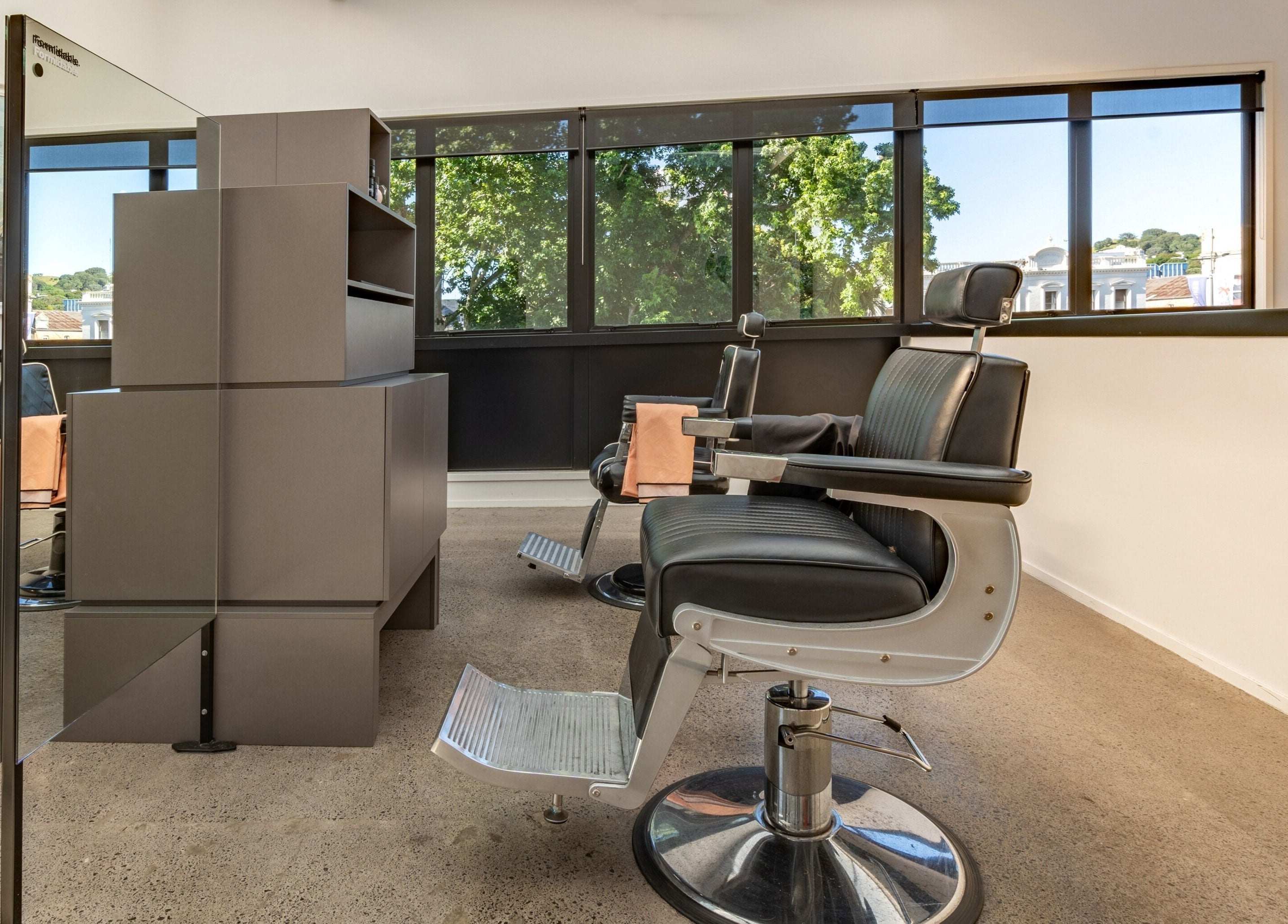 Modern barber chairs in Urban Goose, Auckland, Auckland, NZ offering stylish grooming services.