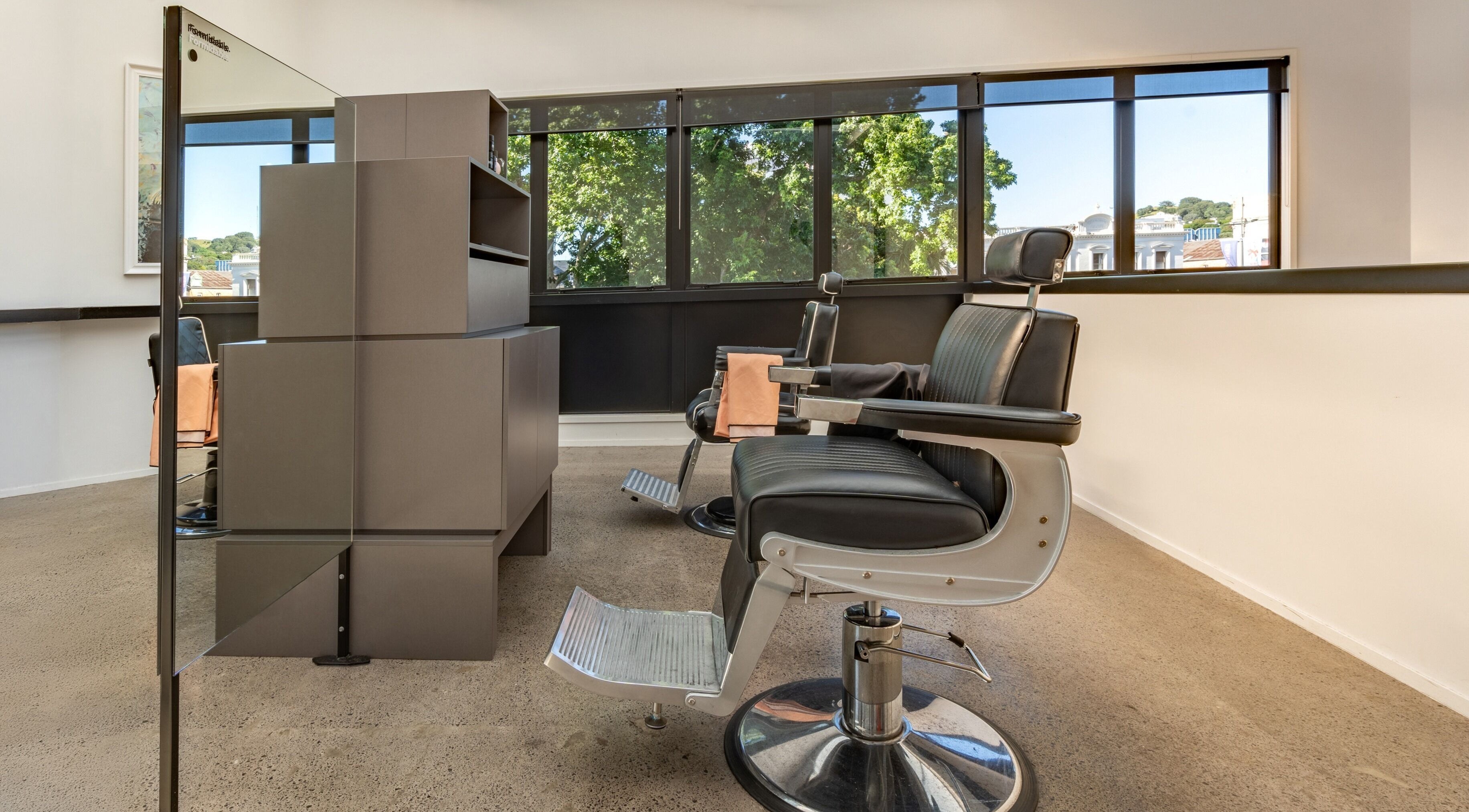 Modern barber chairs in Urban Goose, Auckland, Auckland, NZ offering stylish grooming services.