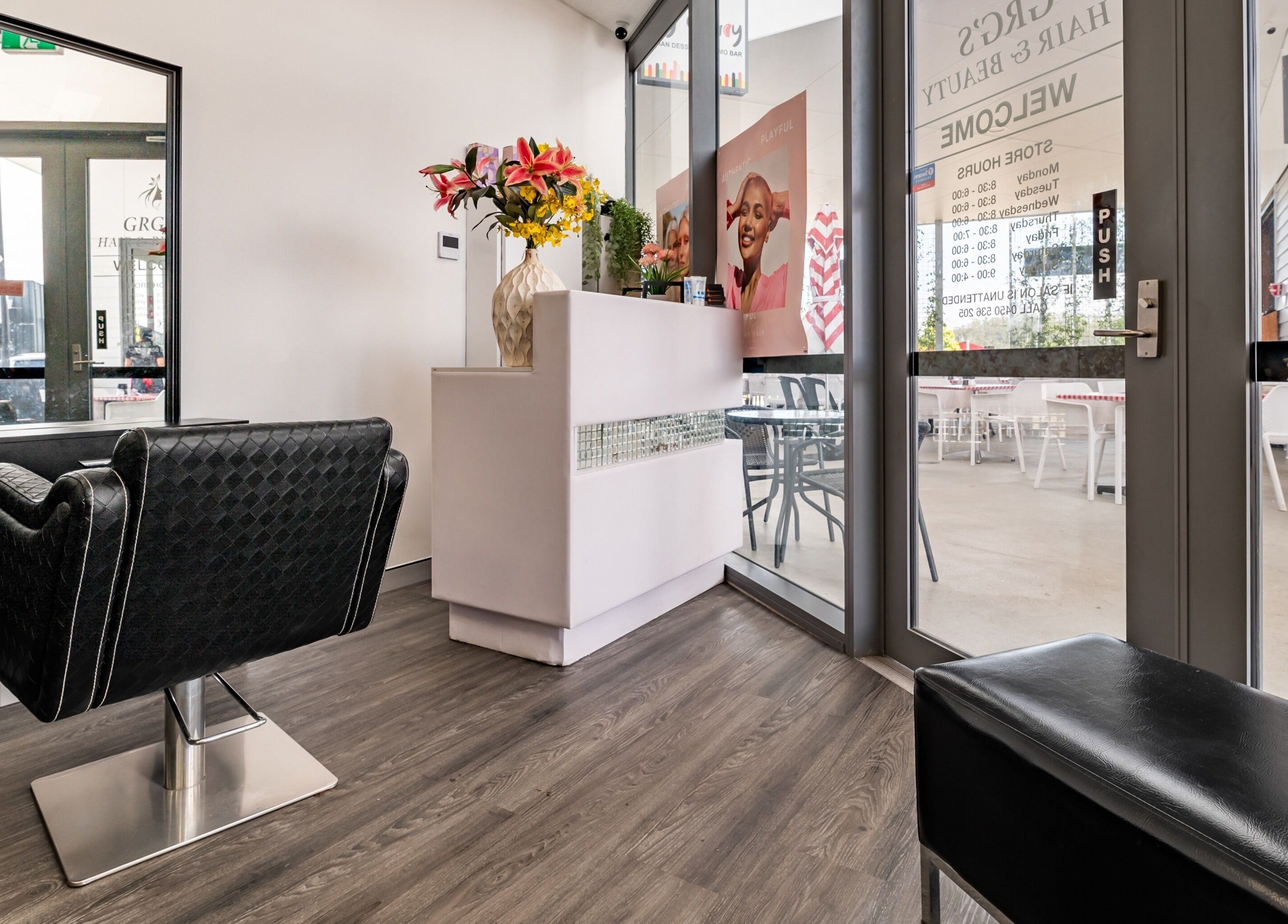 Modern salon interior at GRG's Hair & Beauty, Spring Mountain, Queensland, AU with stylish seating and floral decor.