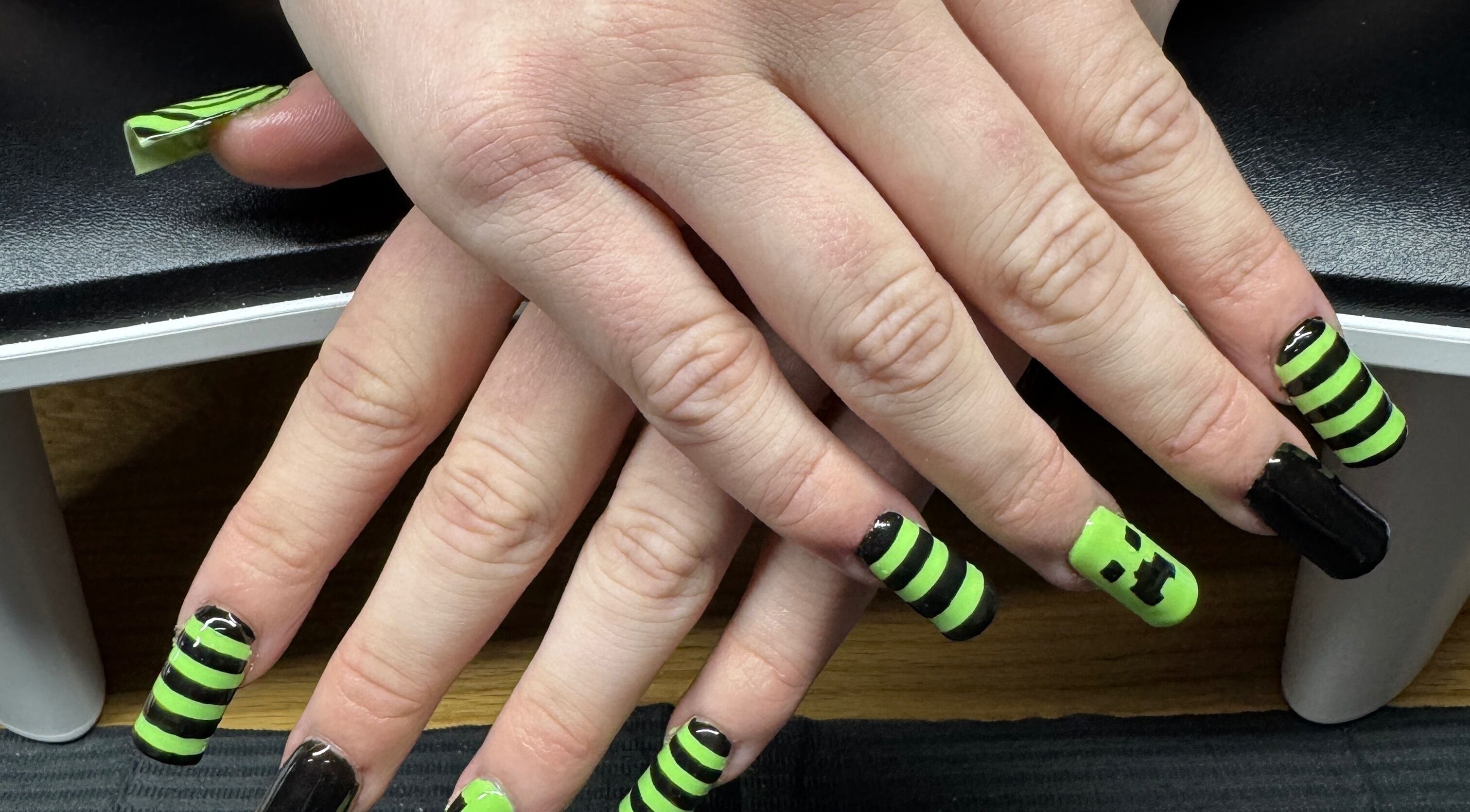 Lime green and black striped nails at Bullet Beauty Bar, Meadow Springs, Western Australia, AU.