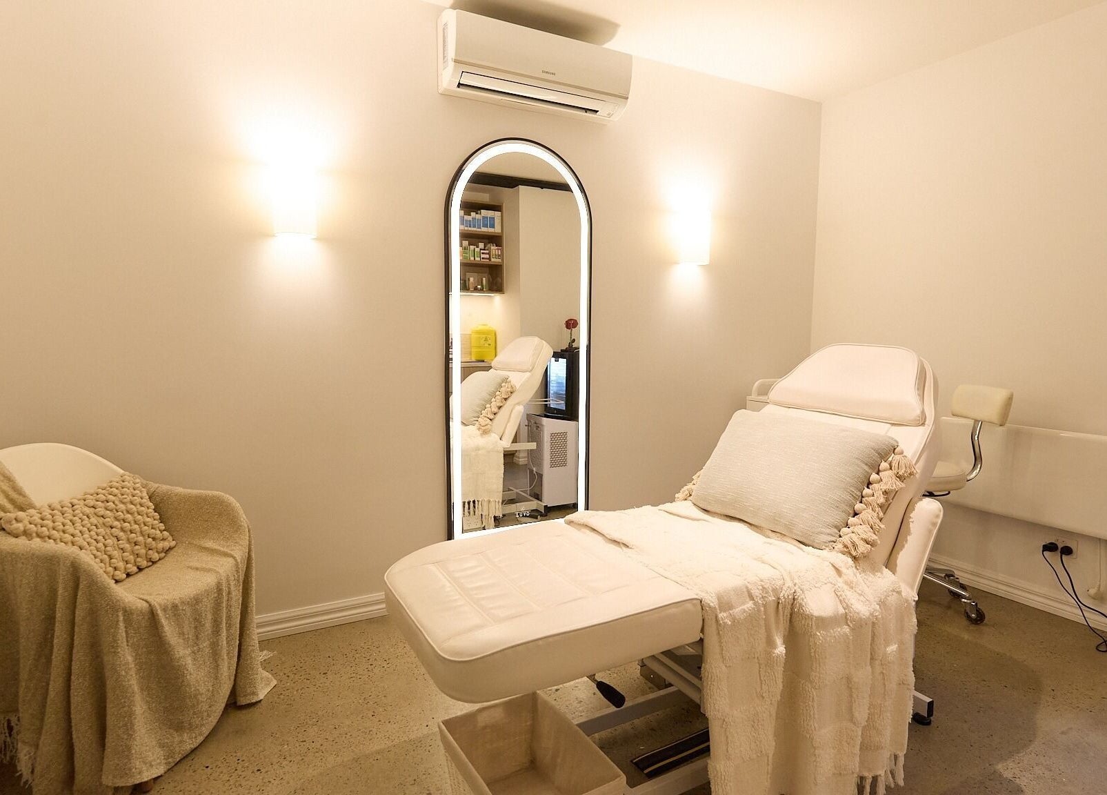 Rejuvee's tranquil treatment room in Surry Hills, New South Wales, AU with plush seating and soft lighting.