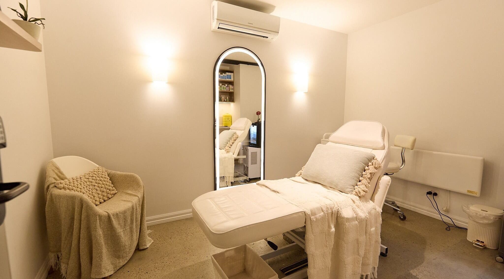 Rejuvee's tranquil treatment room in Surry Hills, New South Wales, AU with plush seating and soft lighting.