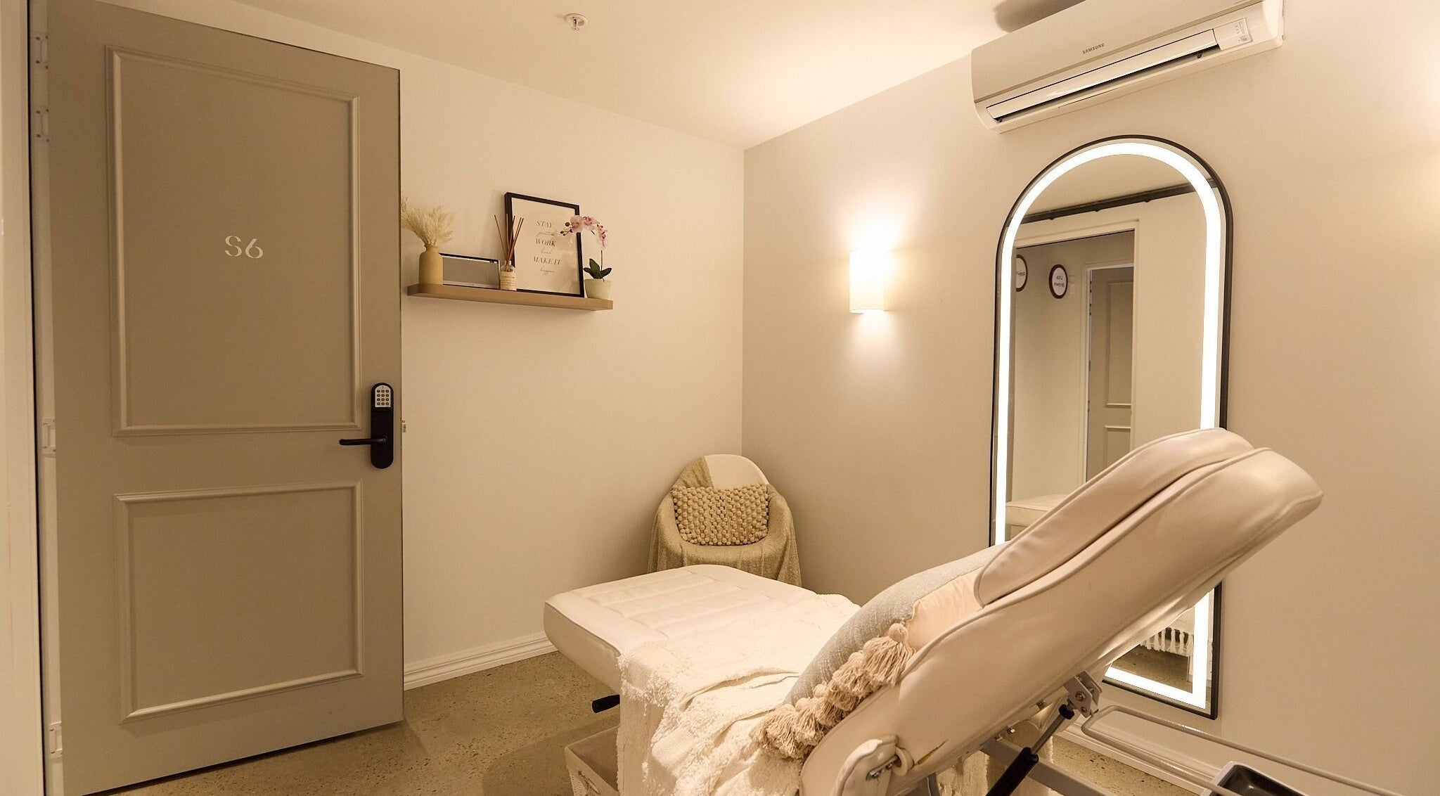 Rejuvee's serene treatment room in Surry Hills, New South Wales, AU, featuring plush seating and a soft-lit ambiance.