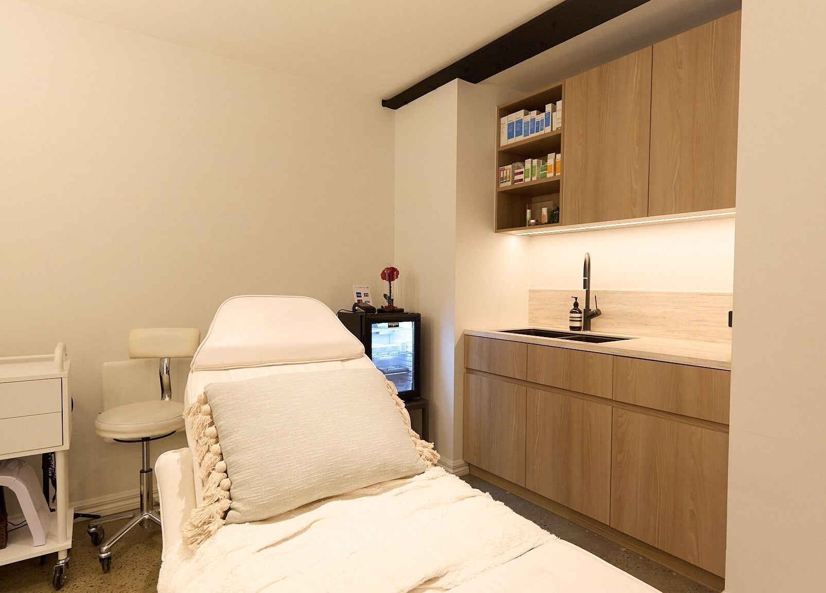 Calming treatment room in Rejuvee, Surry Hills, New South Wales, AU, featuring a plush bed and modern cabinetry.