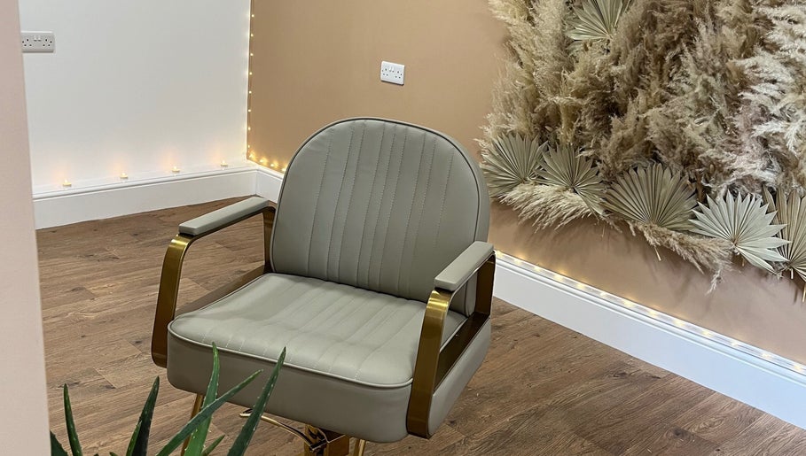 Elegant salon chair at Goddess Rising Hair Extensions, Belper, England, GB with decorative wall accents.