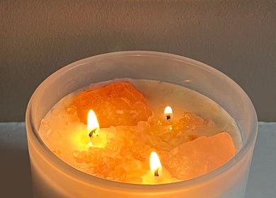 Three glowing candles on crystals at Goddess Rising Hair Extensions, Belper, England, GB create a calming ambiance.