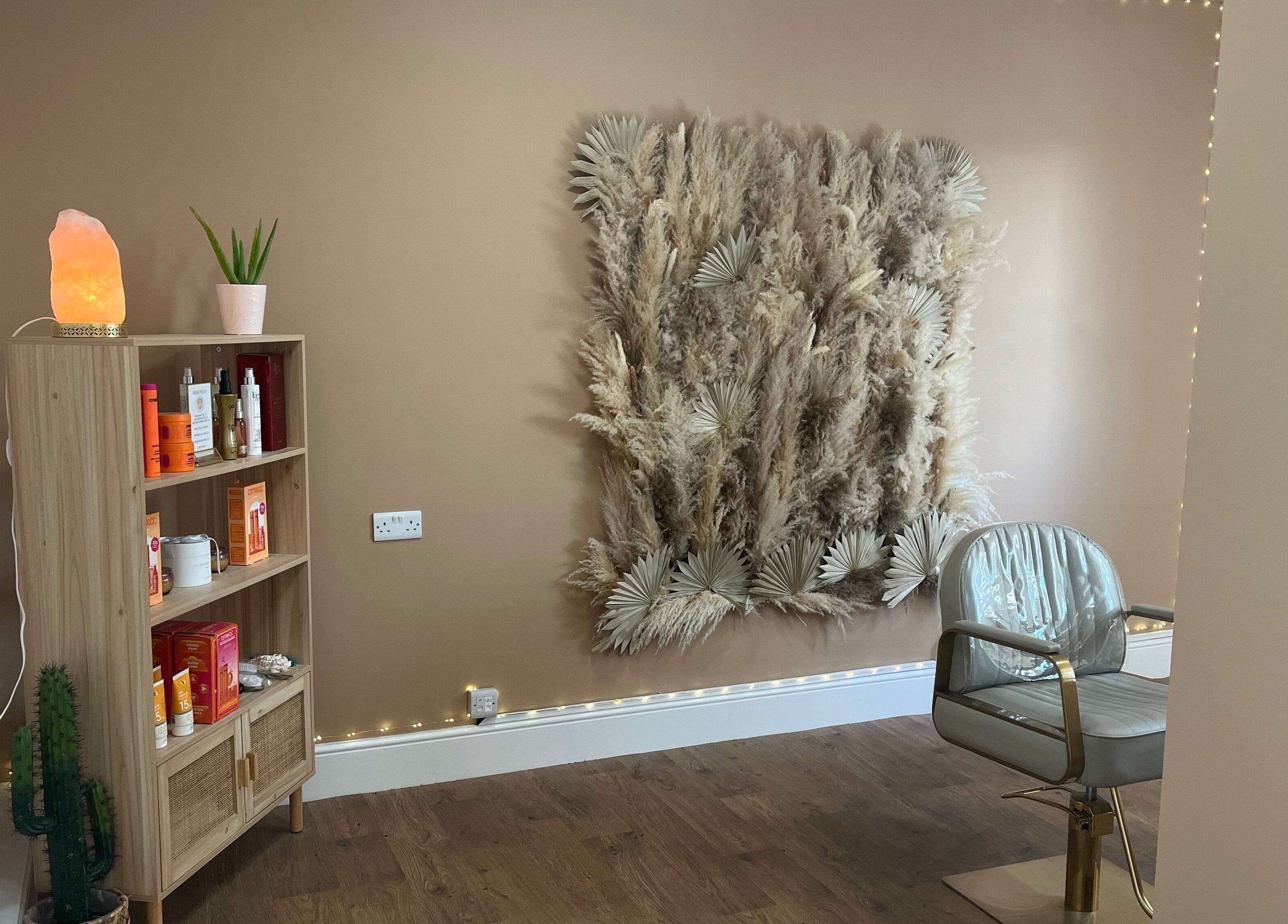 Serene salon corner at Goddess Rising Hair Extensions, Belper, England, GB featuring chic wall decor and a stylish chair.