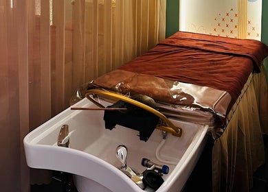 Luxurious treatment room at Moc Kim Spa And Beauty in Hồ Chí Minh, Hồ Chí Minh, VN, featuring a massage bed and washbasin.