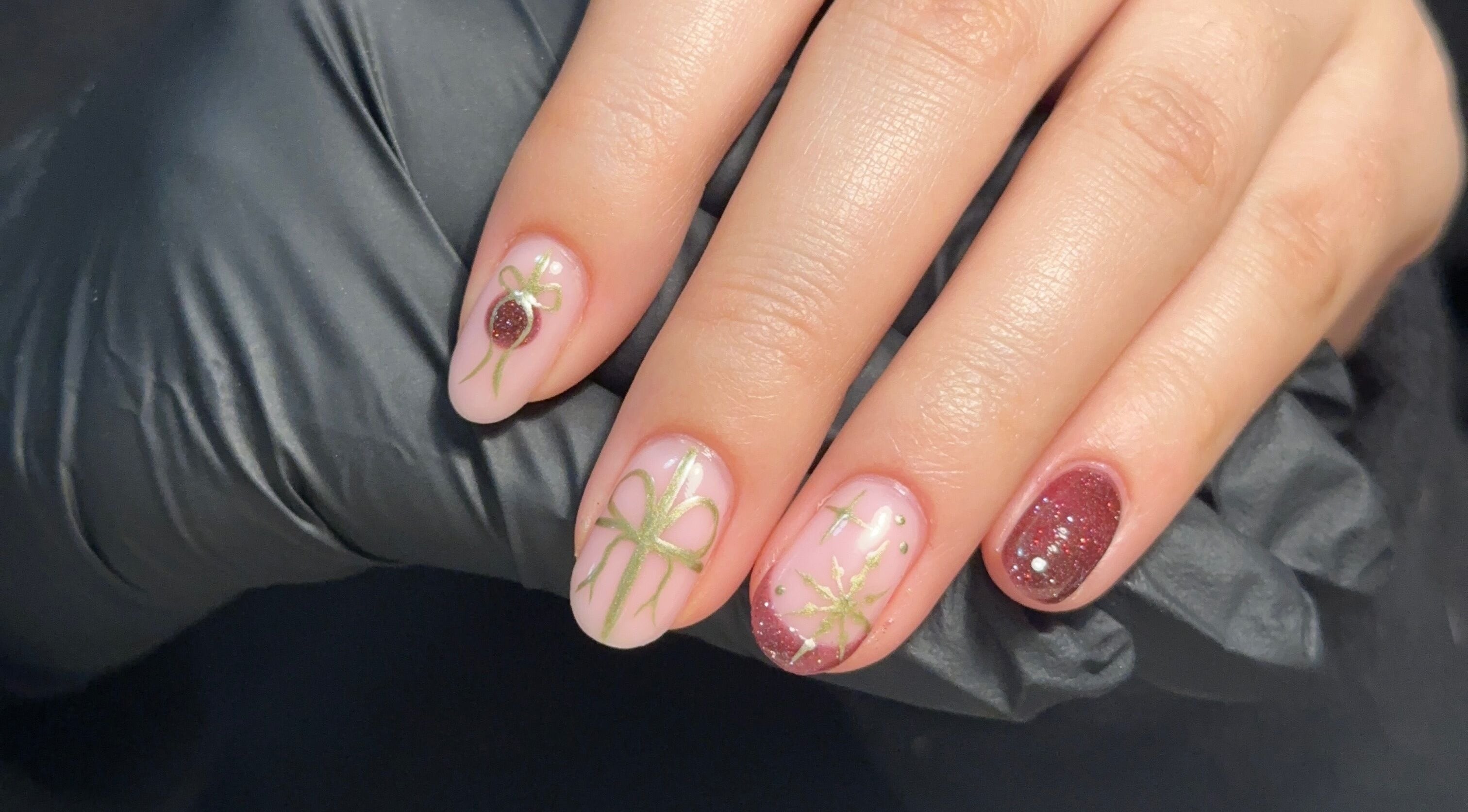 Beautiful festive nail art at Muse Beauty Studio, Port Talbot, Wales, GB, featuring intricate green and red designs.