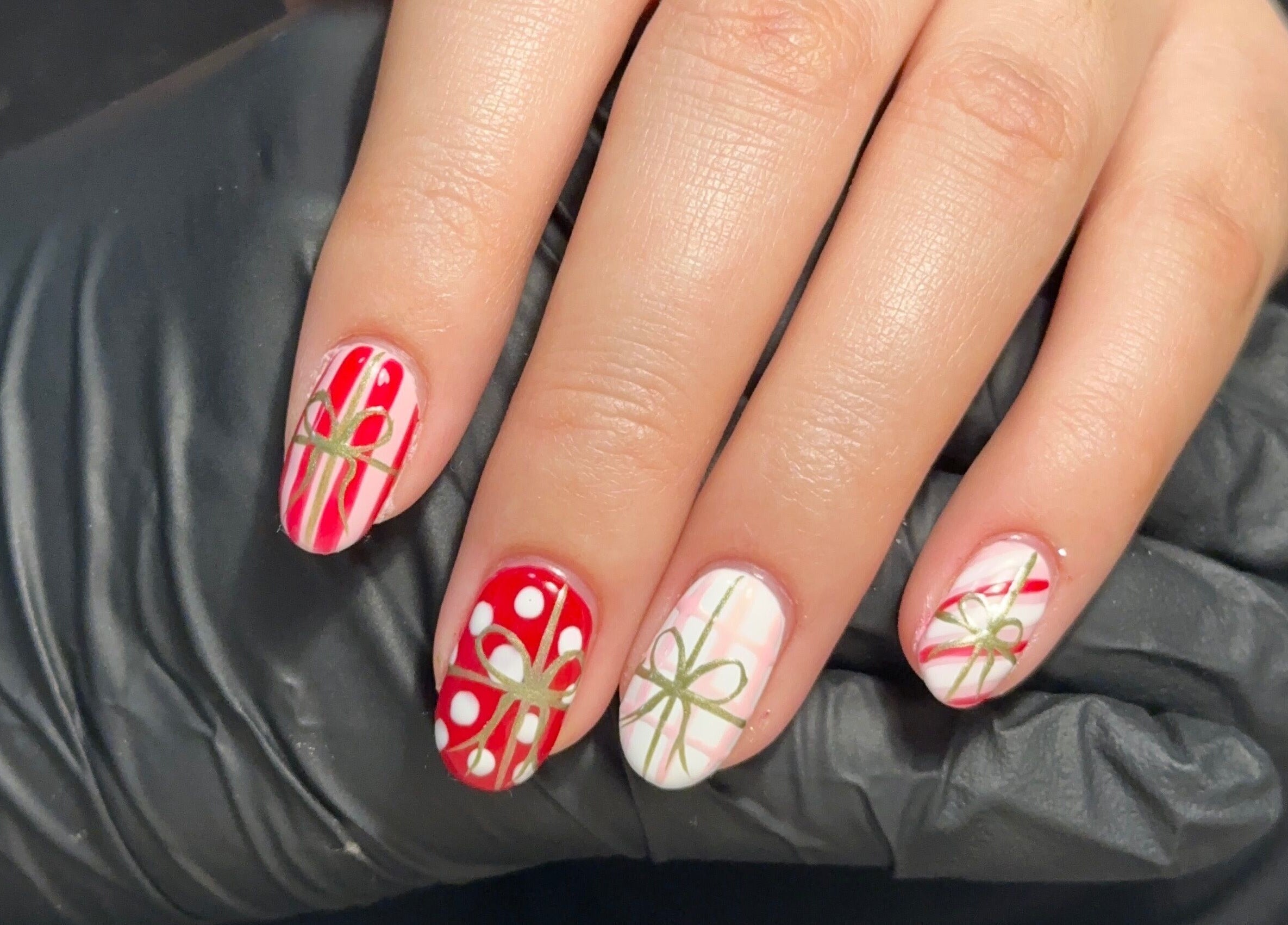 Festive nail designs at Muse Beauty Studio, Port Talbot, Wales, GB, featuring intricate holiday patterns.