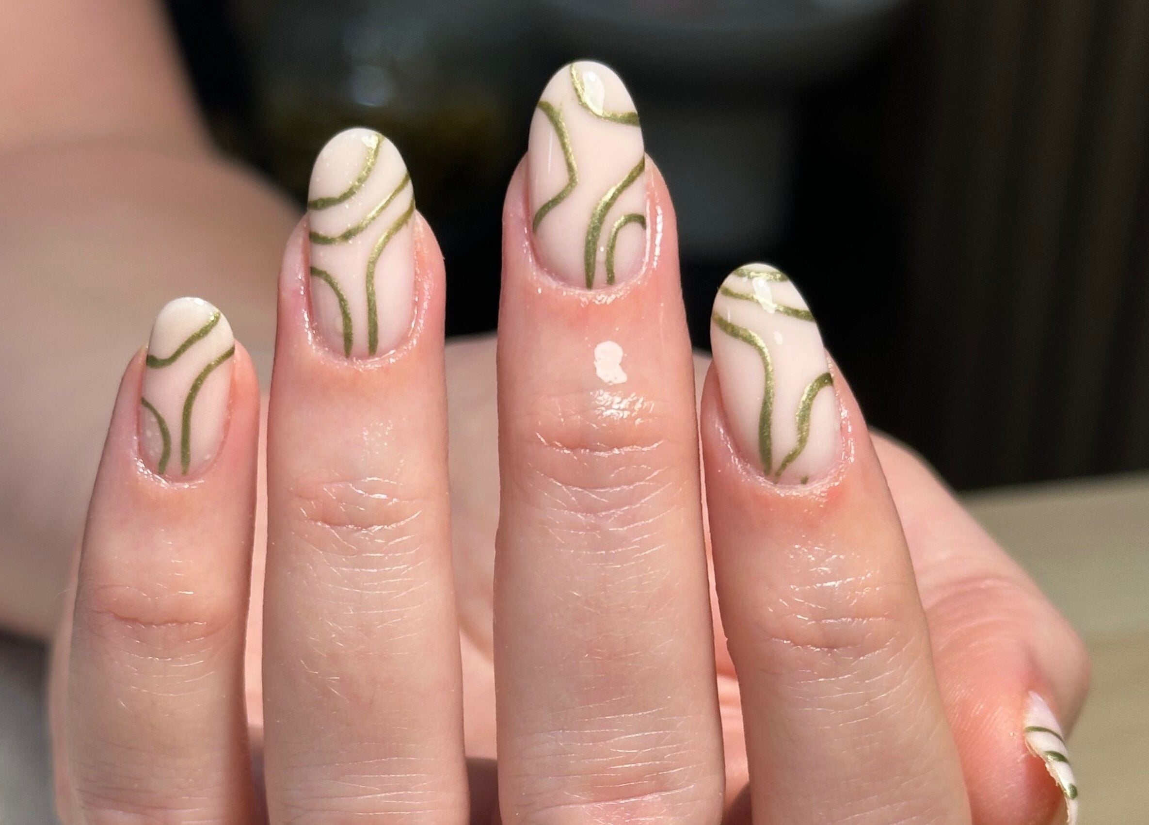 Elegant nail art with green patterns at Muse Beauty Studio in Port Talbot, Wales, GB.