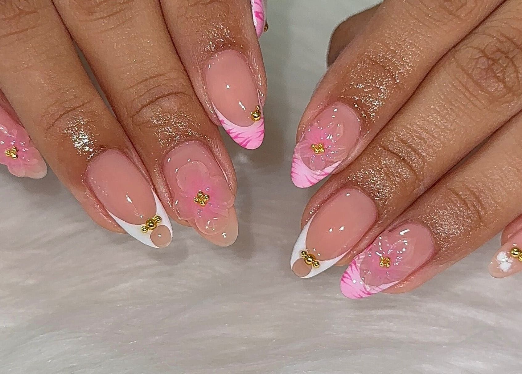 Elegant pink floral nail art at Fantasy Nails Miami, Miami, Florida, US, showcasing intricate design and style.