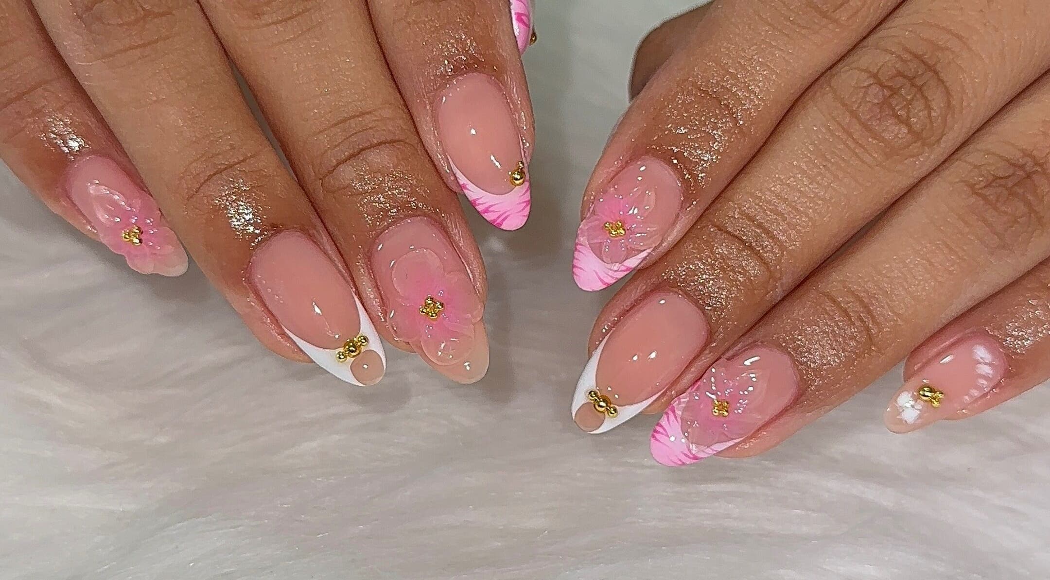 Elegant pink floral nail art at Fantasy Nails Miami, Miami, Florida, US, showcasing intricate design and style.