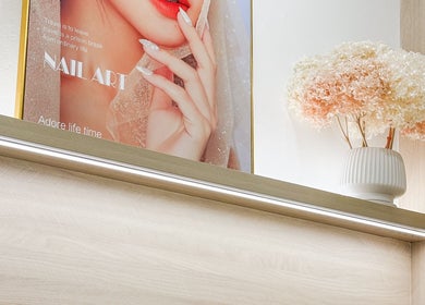 The Skin Edit, Singapore, SG: Elegant nail art poster and floral decor illuminate salon space.