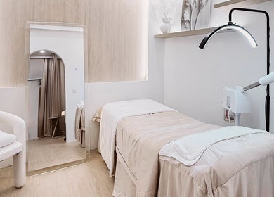 Elegant treatment room at The Skin Edit, Singapore, SG, featuring cozy bedding and soft lighting.