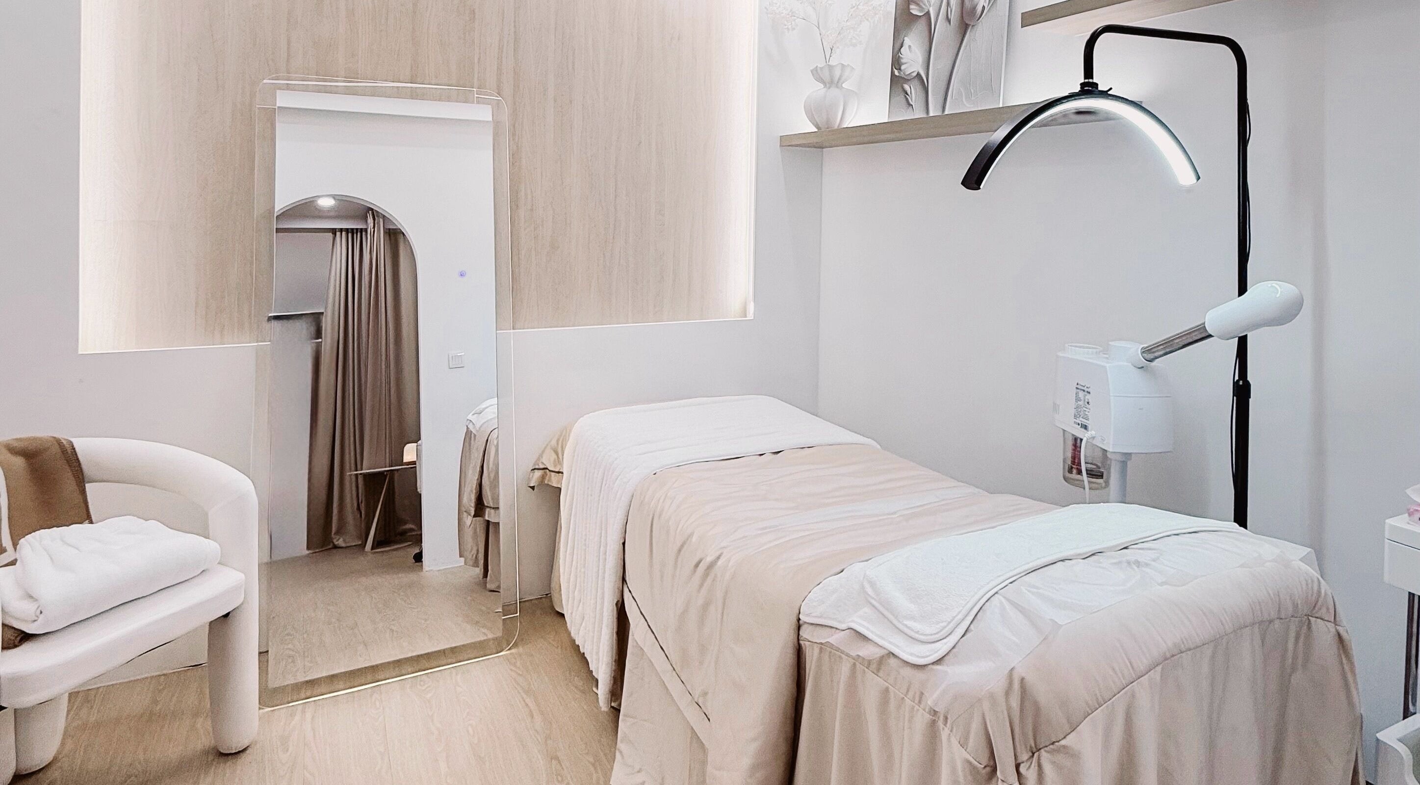 Elegant treatment room at The Skin Edit, Singapore, SG, featuring cozy bedding and soft lighting.