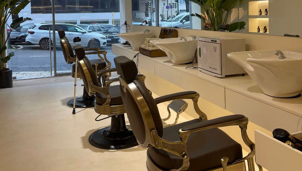 Interior of Barbieri Barbershop & SPA, Lisboa, Lisboa, PT, showing vintage barber chairs and washing stations.